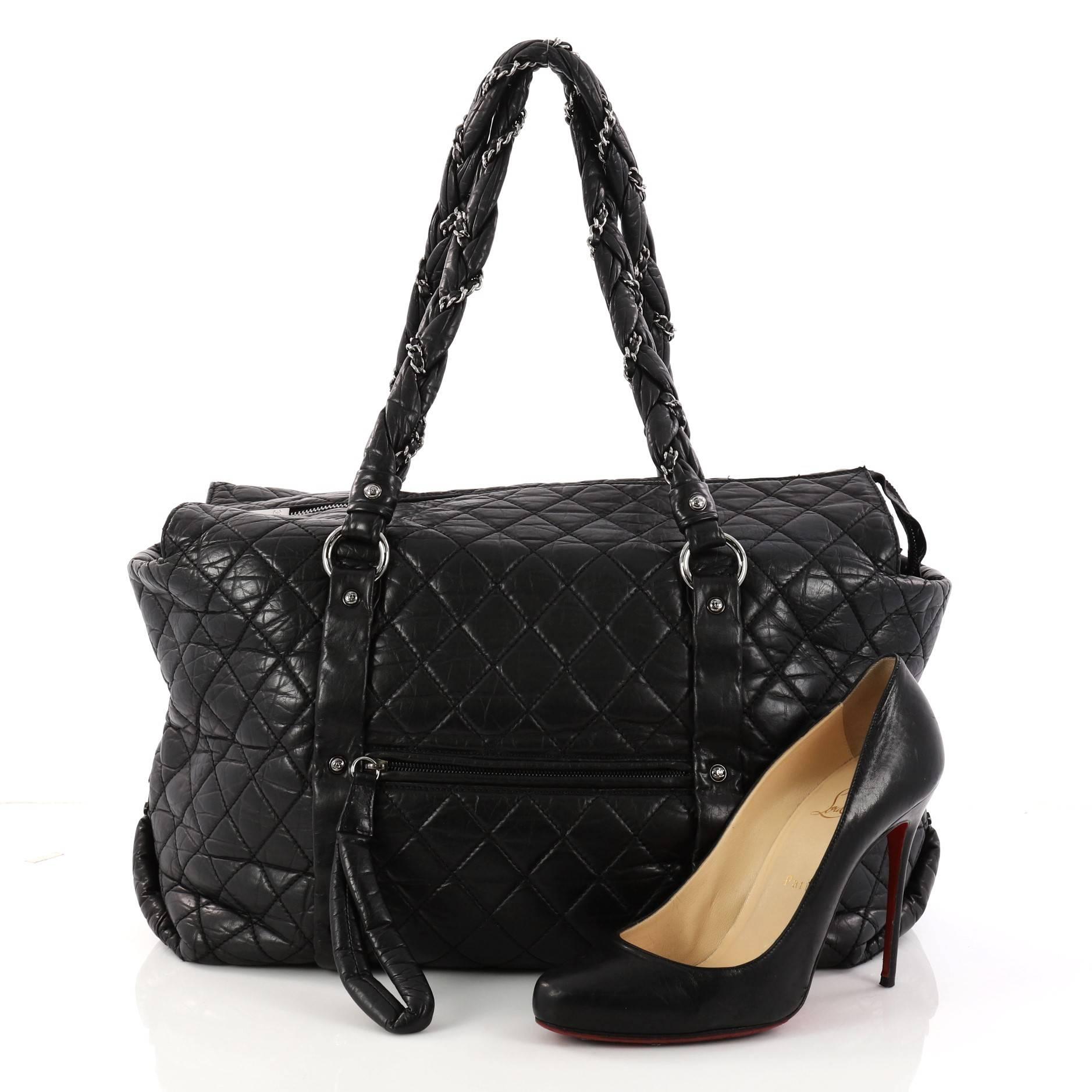 This authentic Chanel Ligne Lady Braid Tote Quilted Leather XL is perfect for the on-the-go fashionista for everyday use and light travel. Constructed from black diamond quilted distressed leather, this oversized tote features intertwined woven