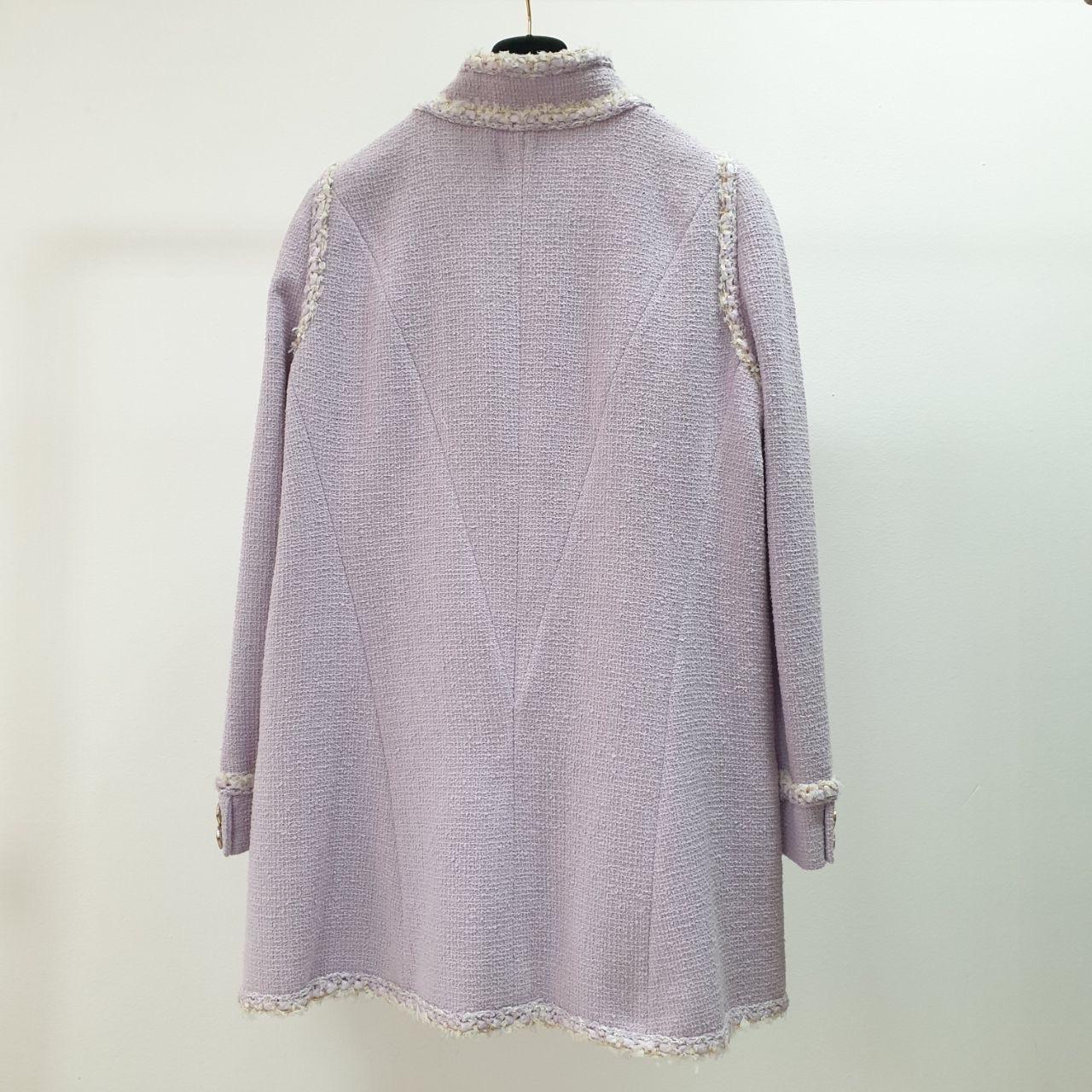 Gorgeous lilac tweed jacket/coat from ''Paris - Versailles'' 2013 Cruise Collection.
Retail price 6,680 euros
Size mark 46. 
Very good condition. Has yelowness on buttons
CC logo Camellia enameled buttons at front and cuffs.