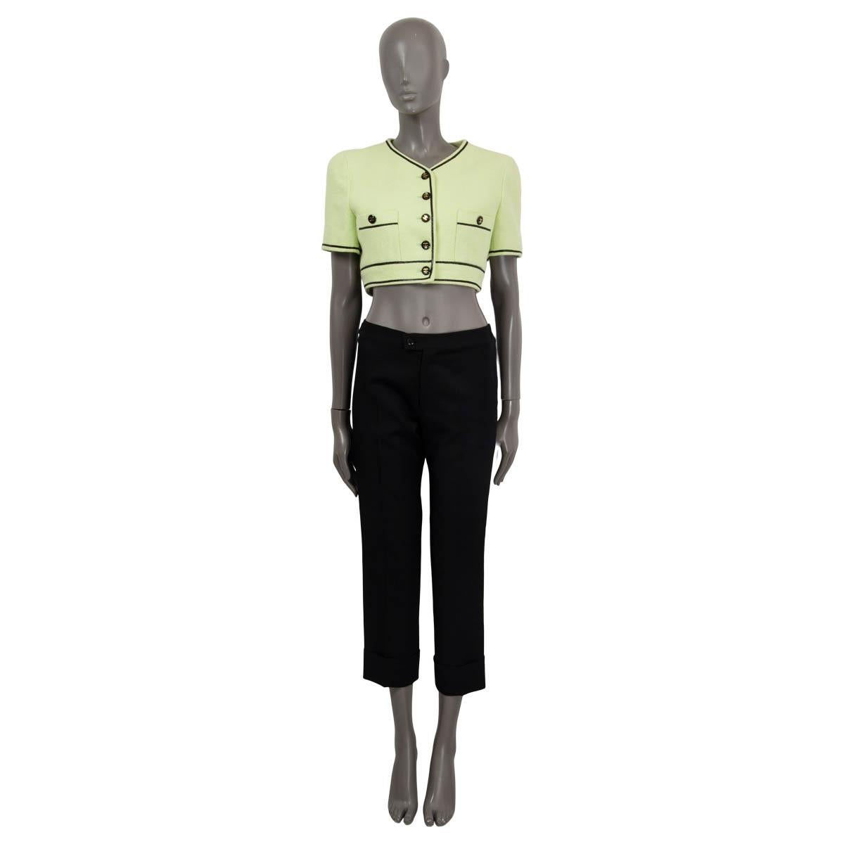 100% authentic Chanel iconic short sleeve cropped jacket in lime green cotton (100%) from the 1995 spring/summer micorsuit collection. Features a black contrast trim and two 'CC' buttoned patch pockets on the front. Opens with 'CC' buttons on the