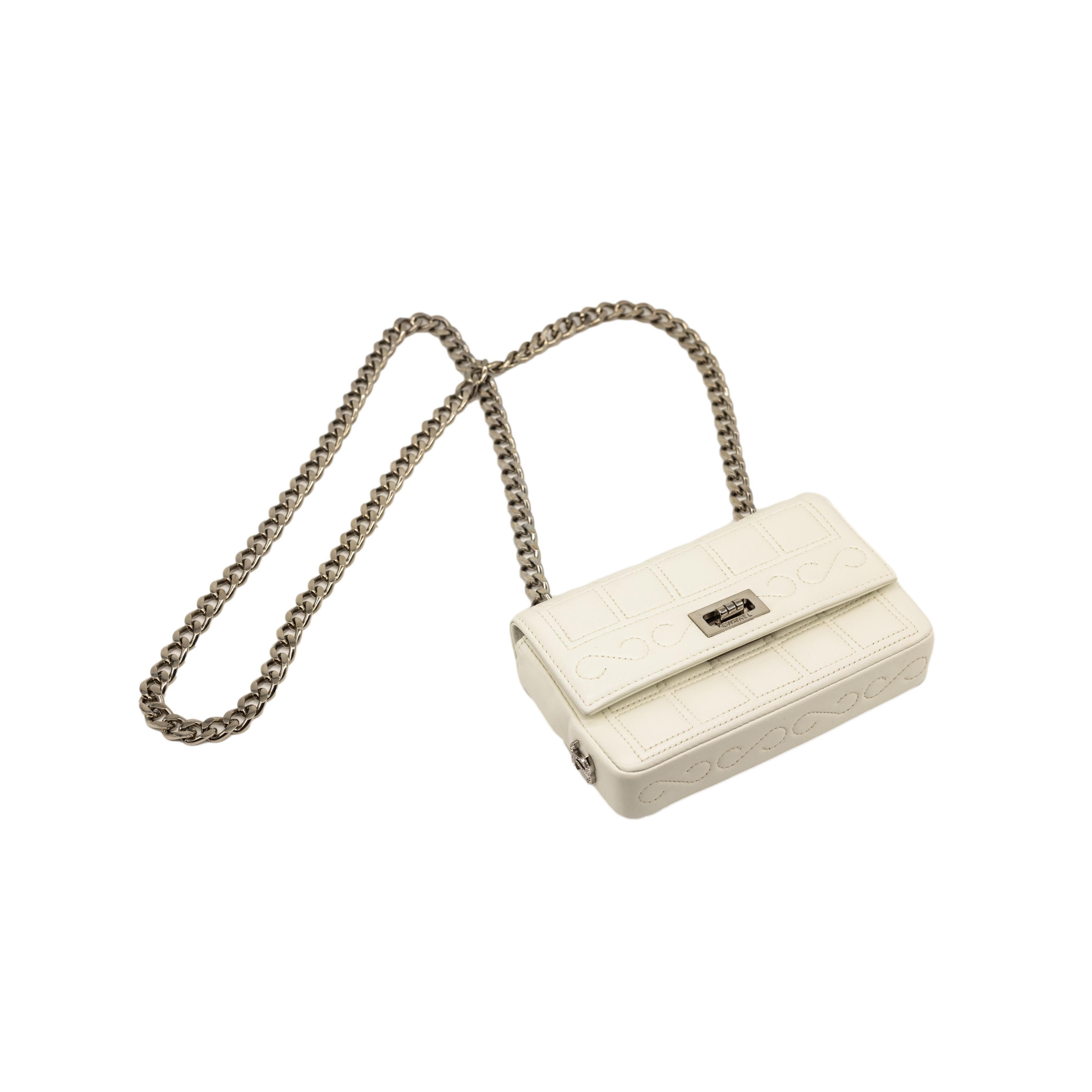 Chanel Limited Edition 2.55 Re-Issue White Mini Chocolate Bar Shoulder Bag, 2002 - 2003. The iconic Chanel bag was originally issued by Coco Chanel in February 1955 which became the very first socially acceptable shoulder bag for the modern day