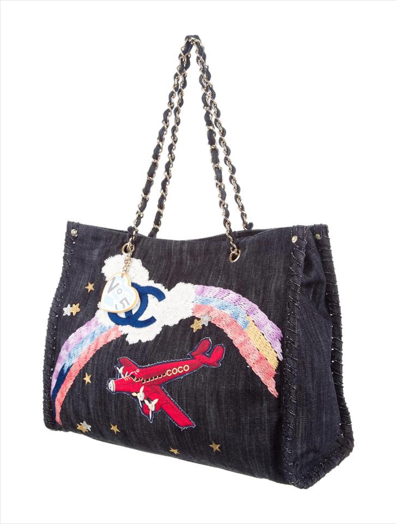 Chanel Limited Edition Airplane Rainbow Mixed Media Blue Jean Denim Tote Rare

2005 {VINTAGE 16 Years}
Silver-gold tone hardware
Dark blue denim 
Pop art logo yellow heart mirror keychain charm
Denim interwoven classic chain straps 
Beige canvas