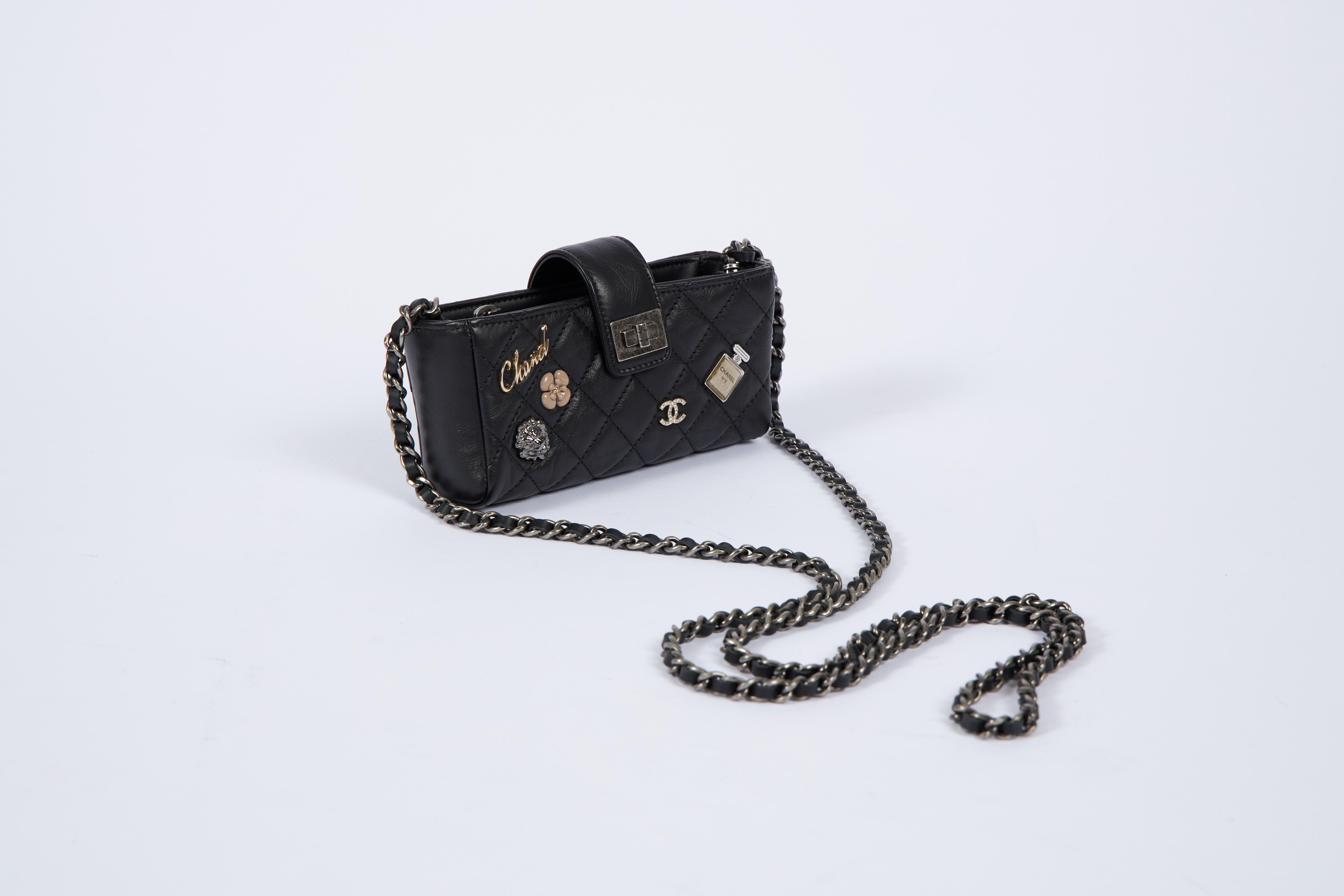 Chanel limited edition reissue black cross body with metal charms. Comes with hologram, ID card, dust cover and box.
