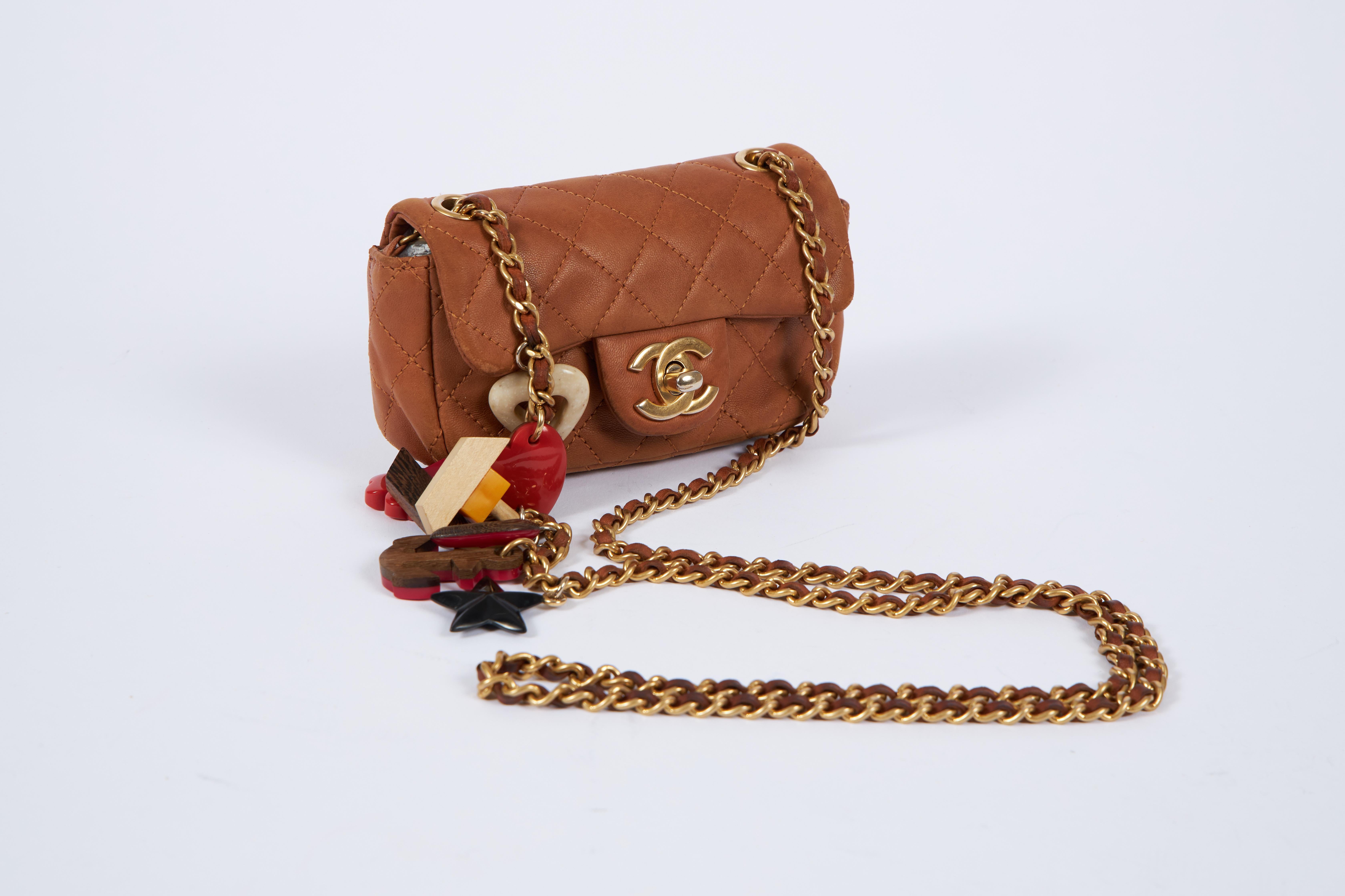 Chanel limited edition mini classic charm bag. Camel brown leather with gold tone hardware. Shoulder strap 23