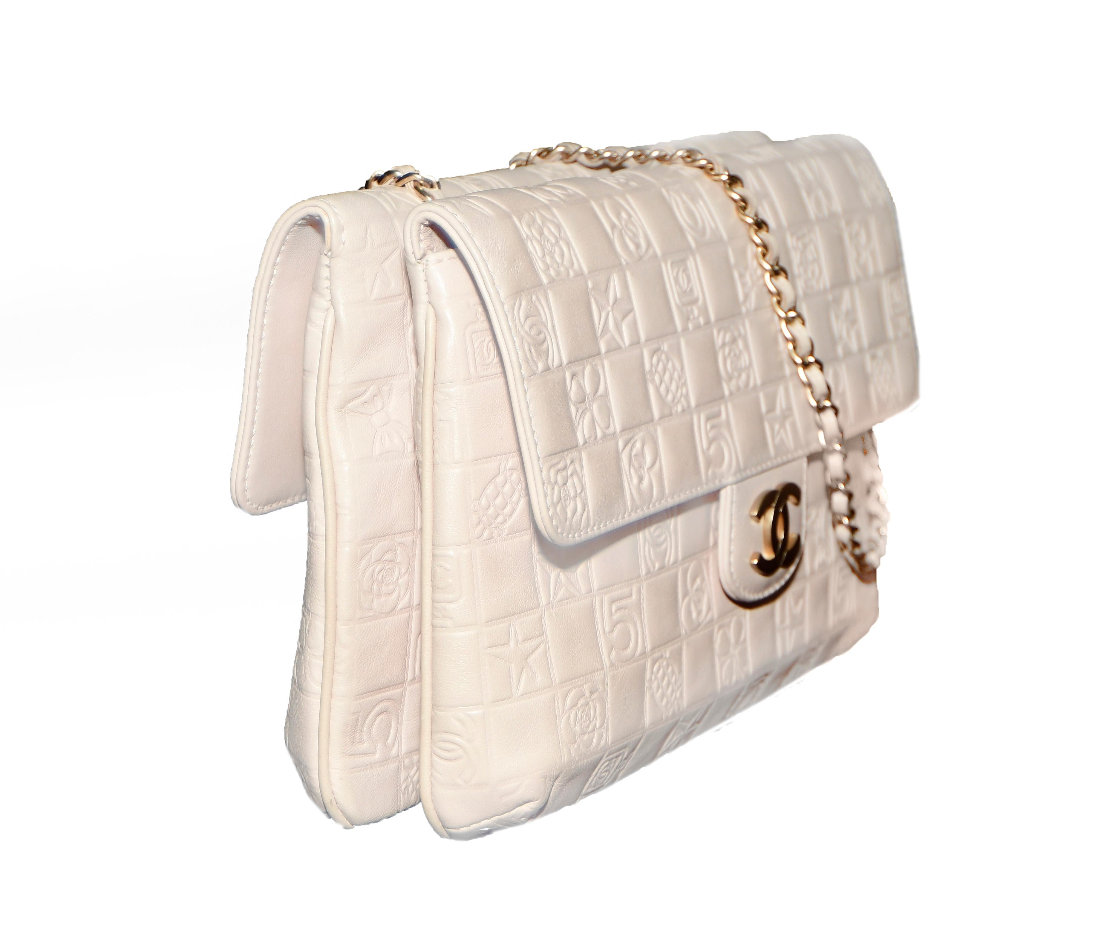 Chanel limited edition logo embossed flap bag in caramel lambskin leather includes two flap bags back to back.  With single leather and chain strap and brushed gold hardware, this bag is lined with Camellia fabric in the two interior pockets.  This