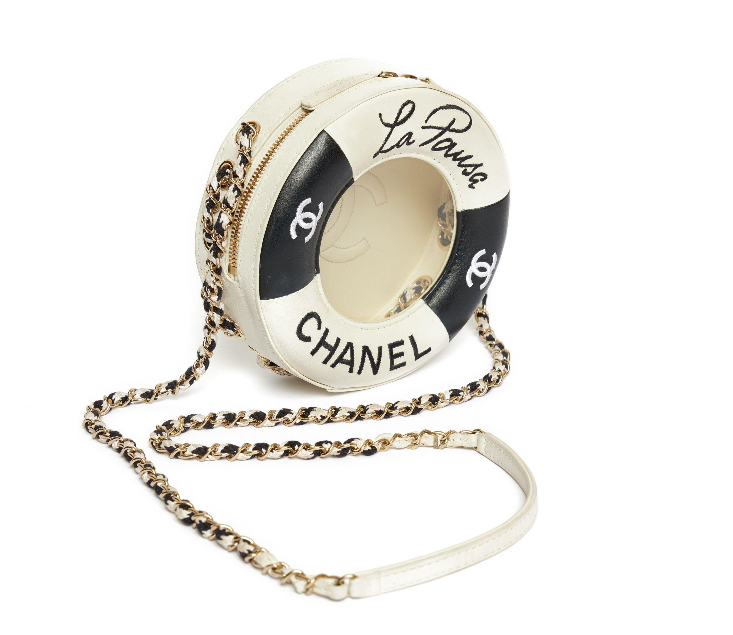 Chanel limited Edition La Pausa bag from the collection of 2019. This beautiful bag is supposed to be a lifebuoy in black in white. On the front it's written La Pausa and Chanel. Also it is see thru so you can see a large CC logo on the inside of