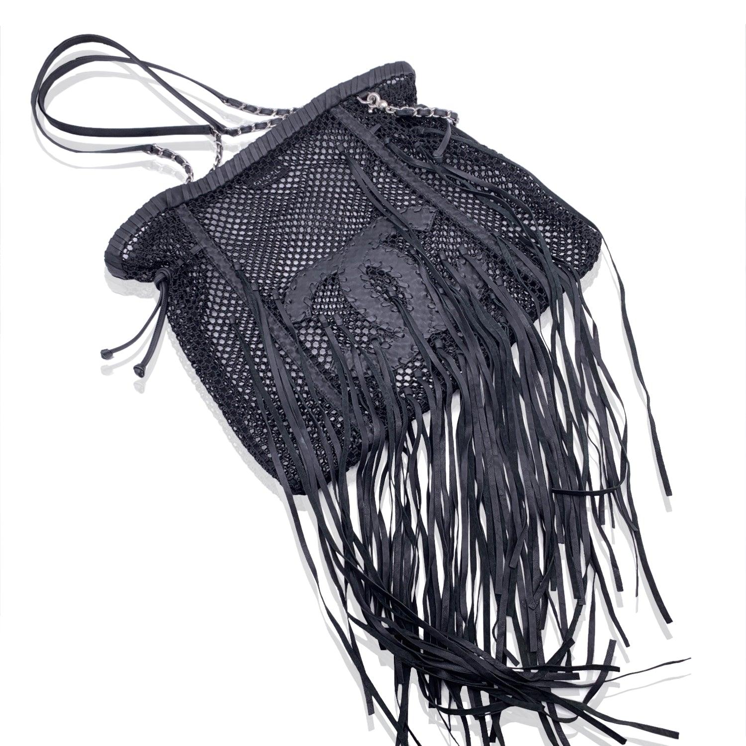 Stunning Chanel Mesh Tote Bag in in black crochet nylon fabric and leather, from the 2011 resort collection. It features a big CC logo in leather with long fringes detailing. Souble leather and silver metal chain shoulder straps. Unlined. 'Chanel -