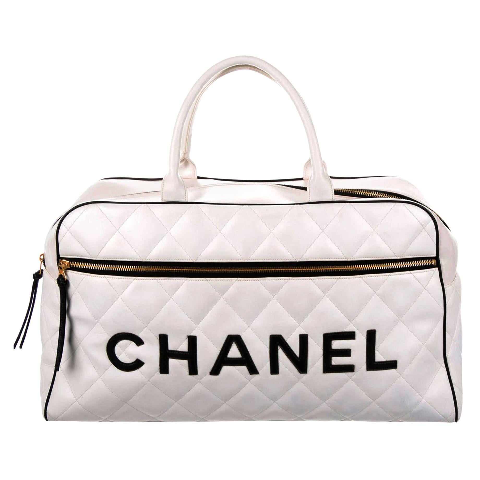 Oversized Chanel quilted logo letters duffel bag leather travel tote. 

1992 {VINTAGE 30 Years}
Black lamb 