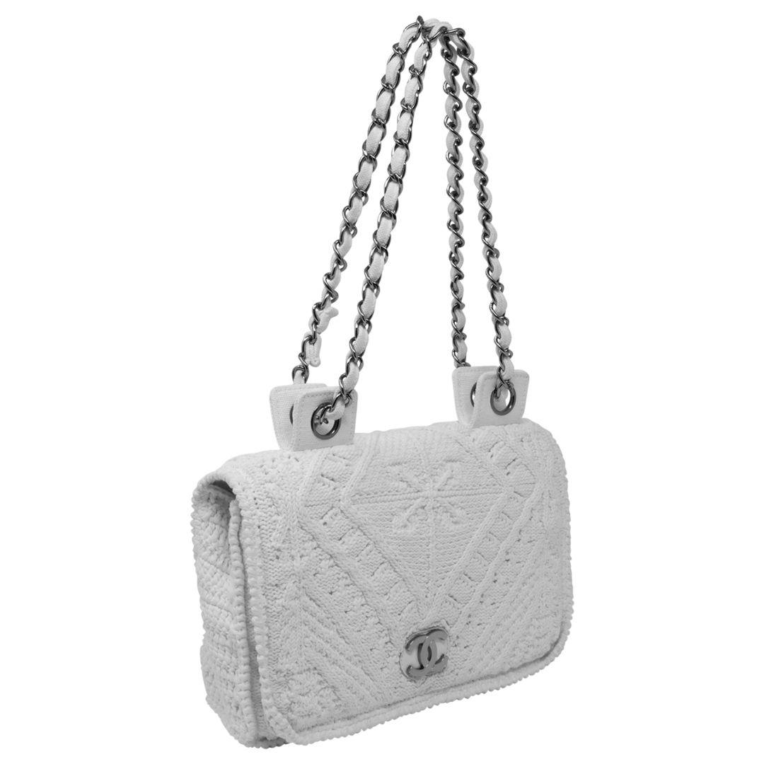If you didn't know already, crochet is IN. This piece is so DE CRU! This extremely rare limited edition crocheted flap bag is detailed in silver-tone hardware, a chain-link shoulder strap that can also be worn doubled up or single, and leather and
