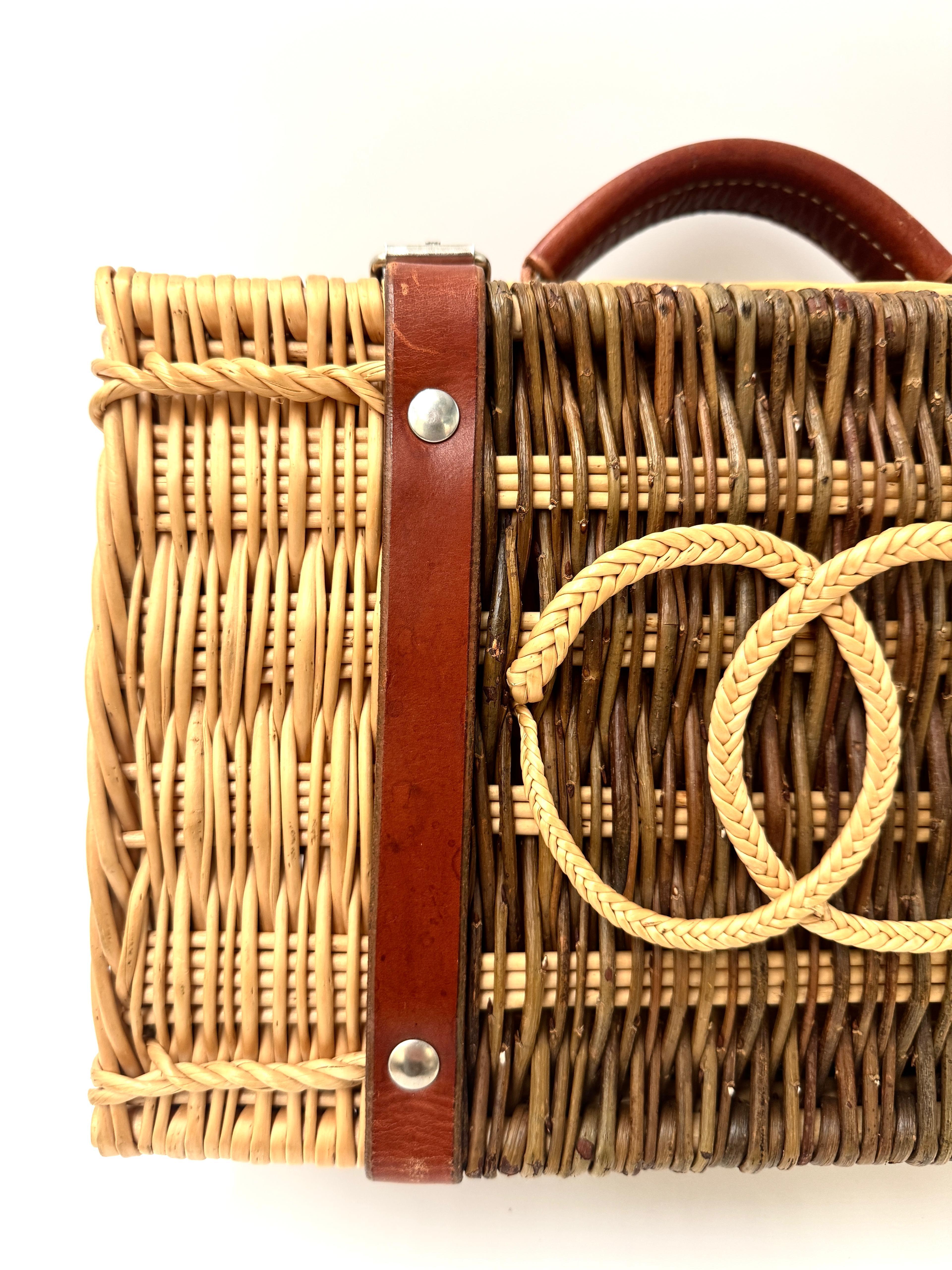 Extremely rare vintage Chanel bocce ball set that’s also famously worn by celebrities as a picnic basket handbag. Crafted from two-tone woven wicker, it features the iconic interlocking CC logo in braided straw and is accented with rich brown