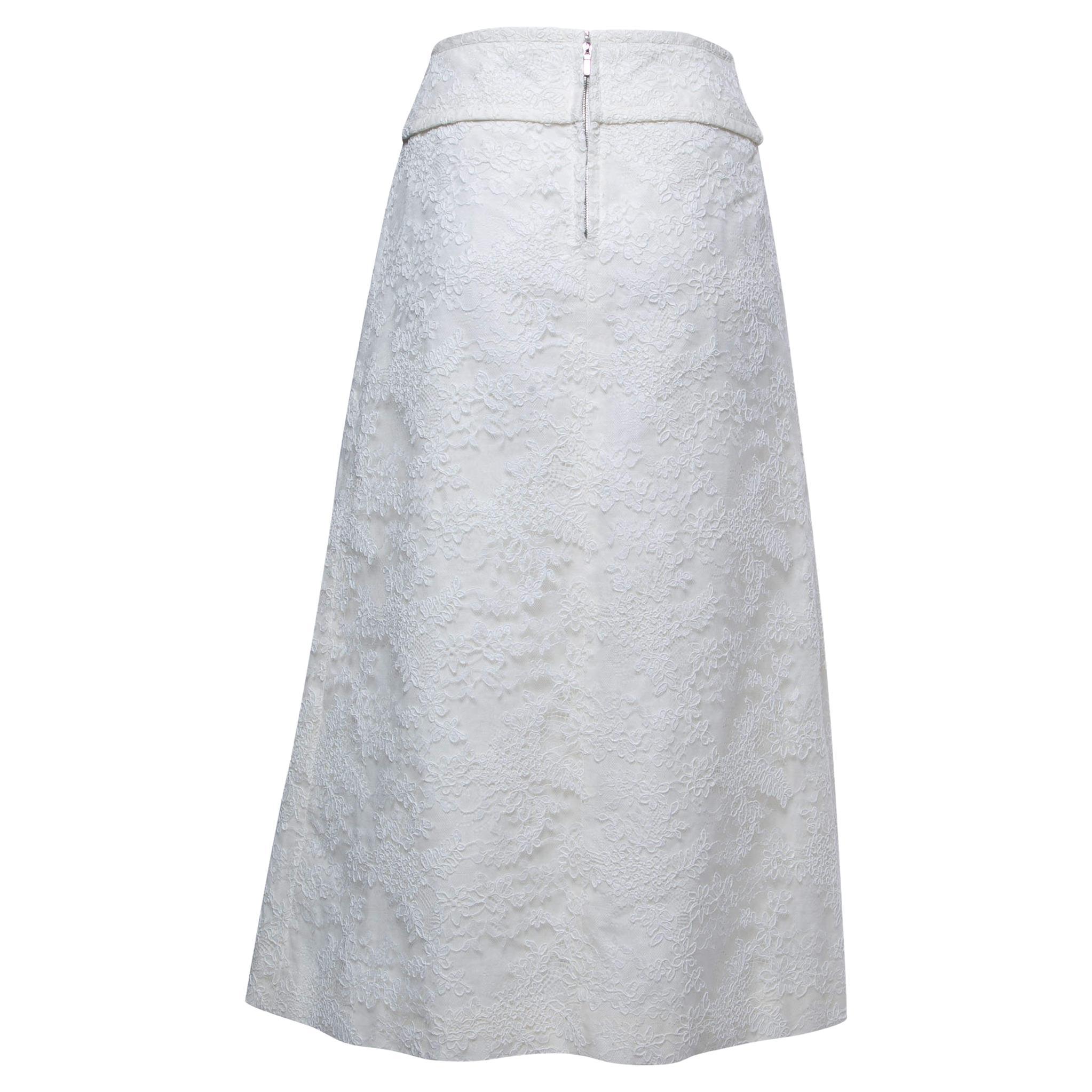 The Chanel skirt is an exquisite fashion piece featuring a blend of soft linen and delicate lace. This knee-length skirt boasts a timeless design with intricate lace detailing, adding a touch of elegance and femininity to any ensemble.

