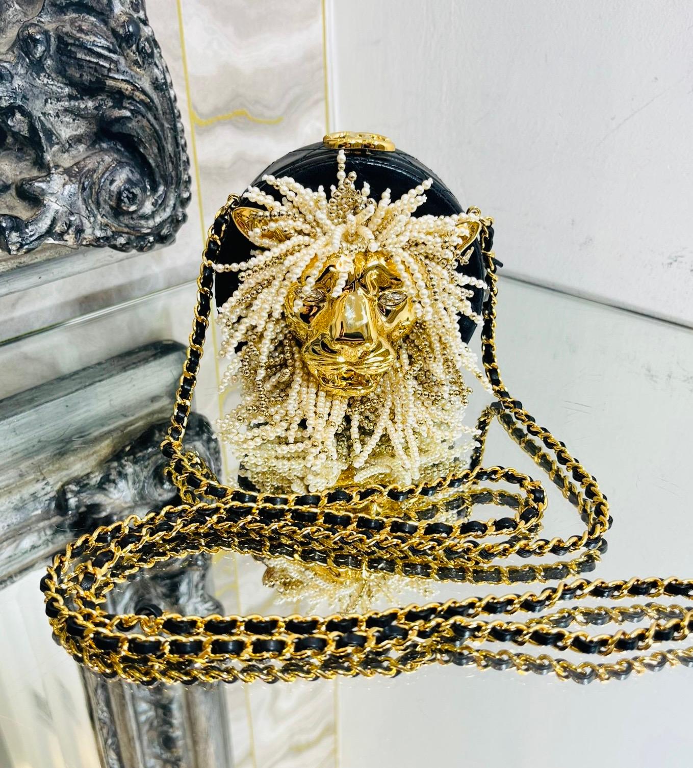 Exceptional Piece - Chanel Lion Head Pearl & Leather Evening Bag

Black, round shaped evening bag crafted from lambskin leather designed with iconic diamond quilting.

Featuring oversized, gold Lion head to the centre detailed with glass pearl mane