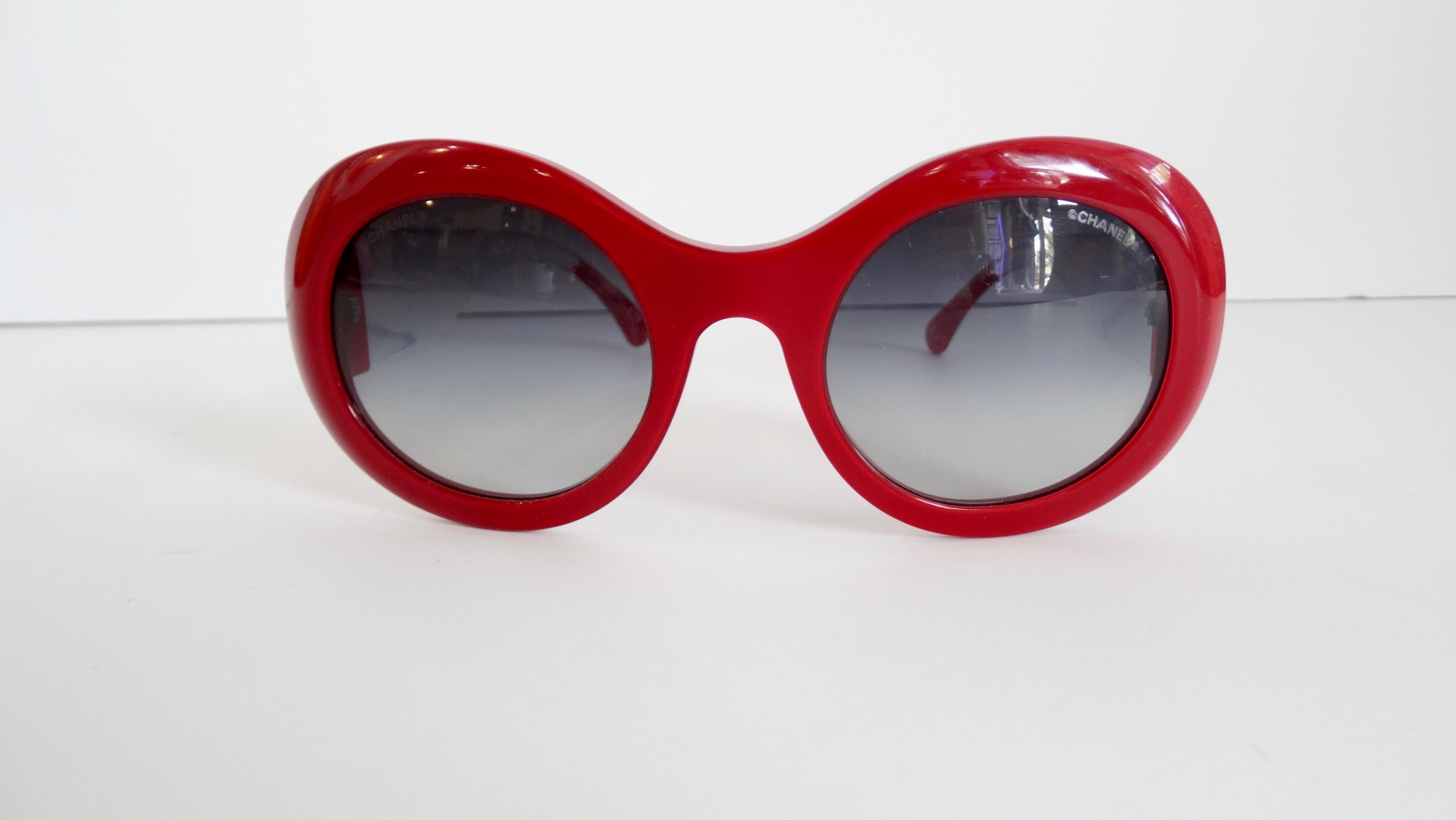 All your sunglass dreams are coming true thanks to Chanel! Circa 21st century, these round sunnies from the Chanel Dream Collection are a lipstick red color with clear acetate arms and gradient lenses. You can find the iconic interlocking CC at the