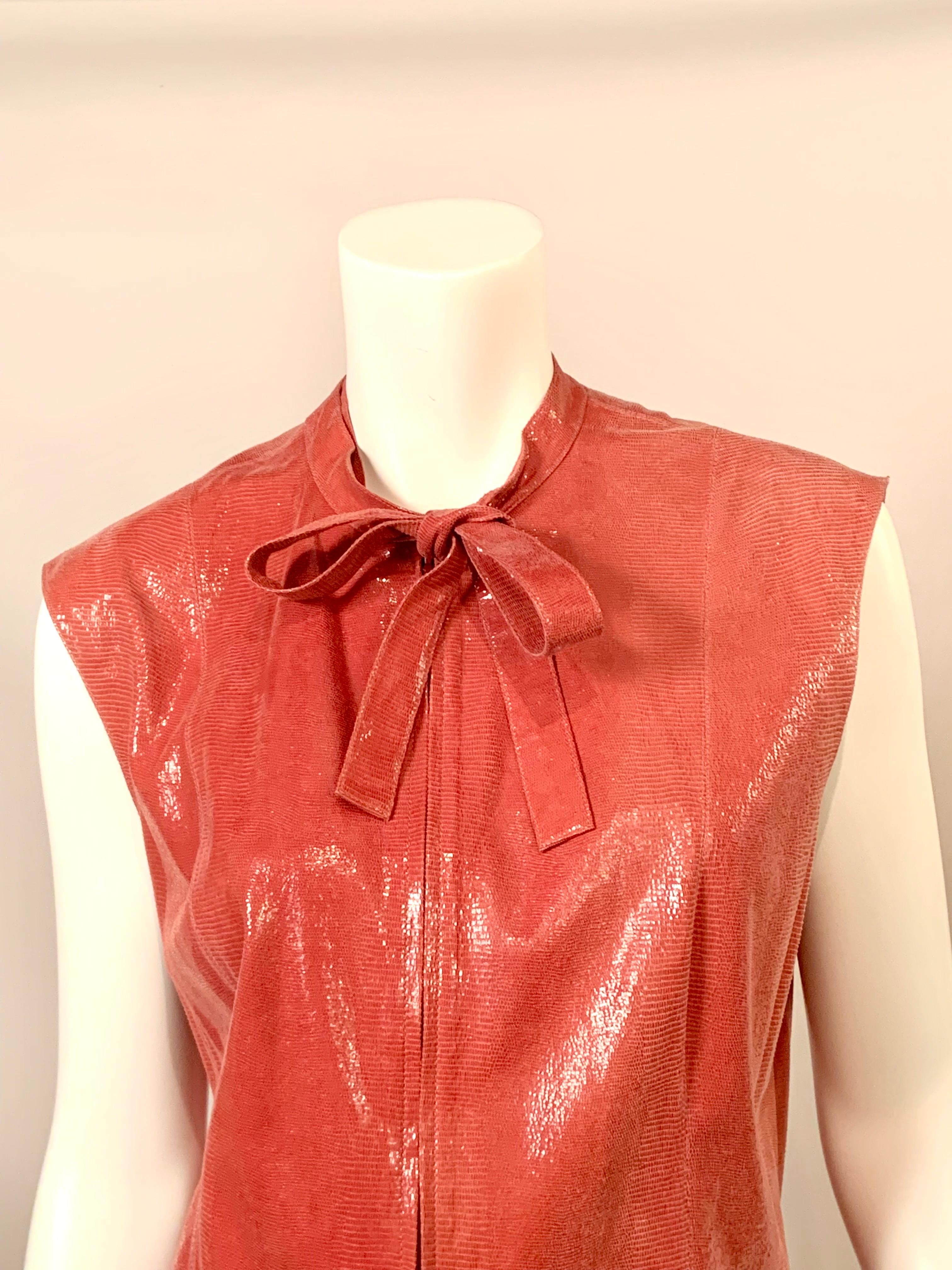 Chanel, Paris rose pink lizard pattern leather vest with a zip front and tie neckline, a very versatile wardrobe item which can easily be dressed up or down. The collar extends to a long tie on either side of the center front zipper. It can be tied