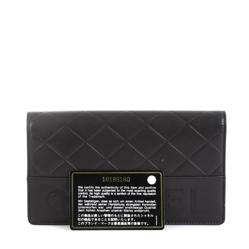 This Chanel Logo Bifold Wallet Quilted Lambskin, crafted from black quilted lambskin leather, features silver-tone hardware. It opens to a black leather interior with multiple card slots, zip pocket and slip pockets. Hologram sticker reads: