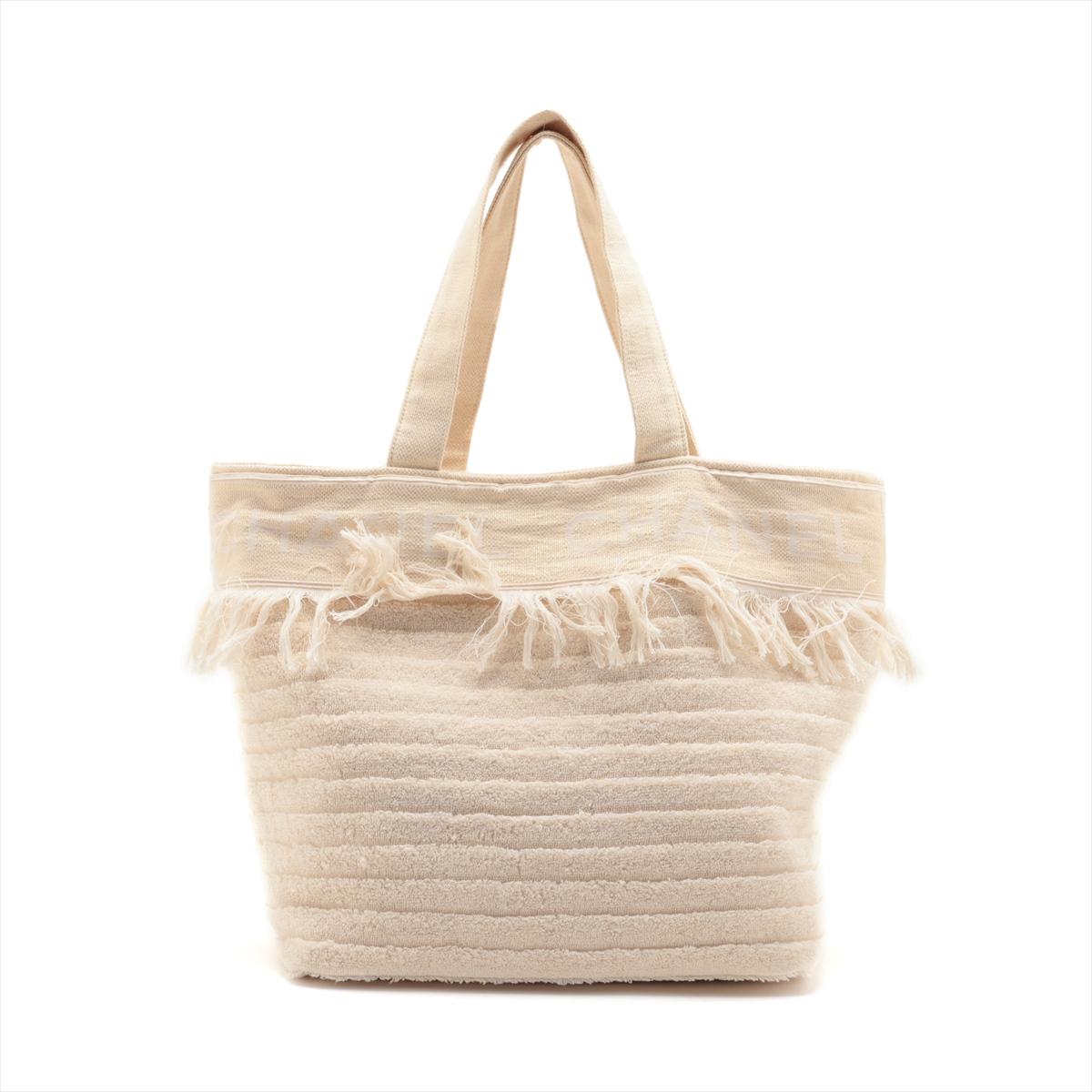 The Chanel Logo Cotton Fringe Tote Bag in Ivory is a chic and stylish accessory that embodies the essence of casual luxury. Crafted from premium cotton, the tote bag features Chanel's iconic logo prominently displayed on the front, adding a touch of