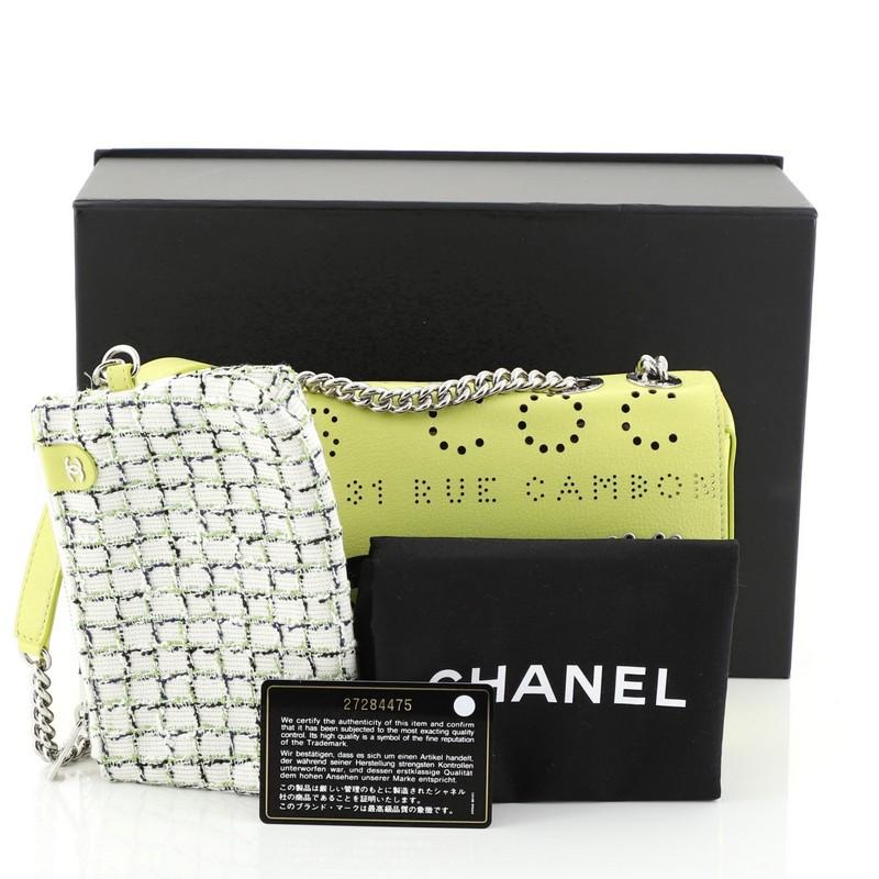 This Chanel Logo Eyelets Flap Bag Perforated Calfskin, crafted from yellow perforated calfskin leather, features chain link strap with leather pad and silver-tone hardware. Its CC turn-lock closure opens to a blue microfiber interior. Hologram