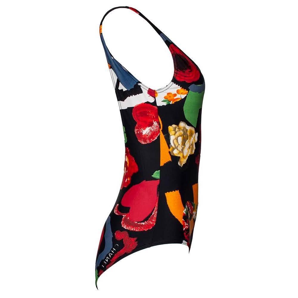 Name something better than CHANEL swim! Maybe vintage Chanel swim? 

This one-piece swimsuit has a beautifully done printed fabric that depicts a black background and highly contrasts it with colors like green, blue, yellow, orange, and red. Seen