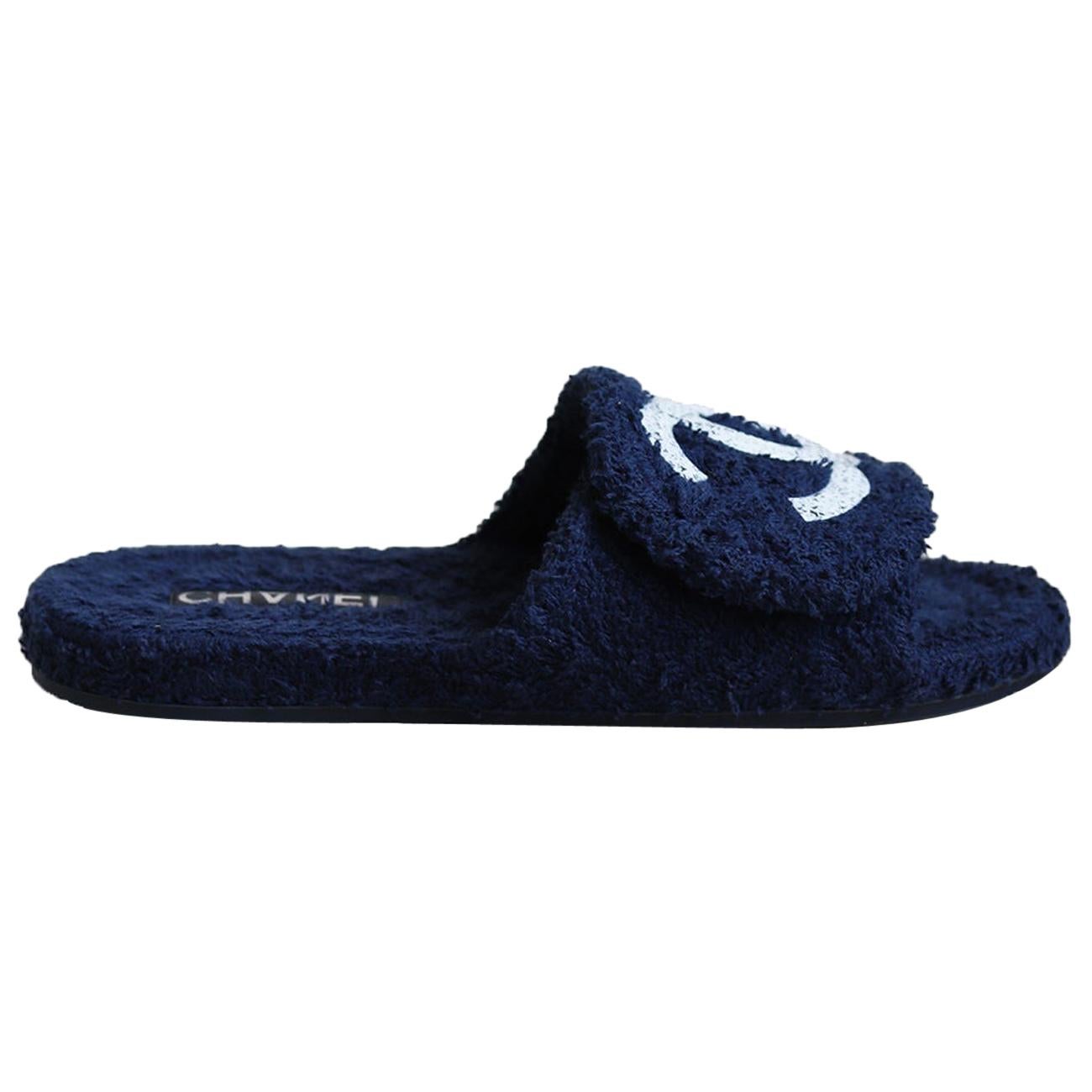 A perfect choice for day or lounging around in the evening, these sandals have been crafted in Italy from navy cotton terry-cloth and rubber soles that beautifully frame the feet. 
Printed tweed plastic logo design along front.
Heel measures