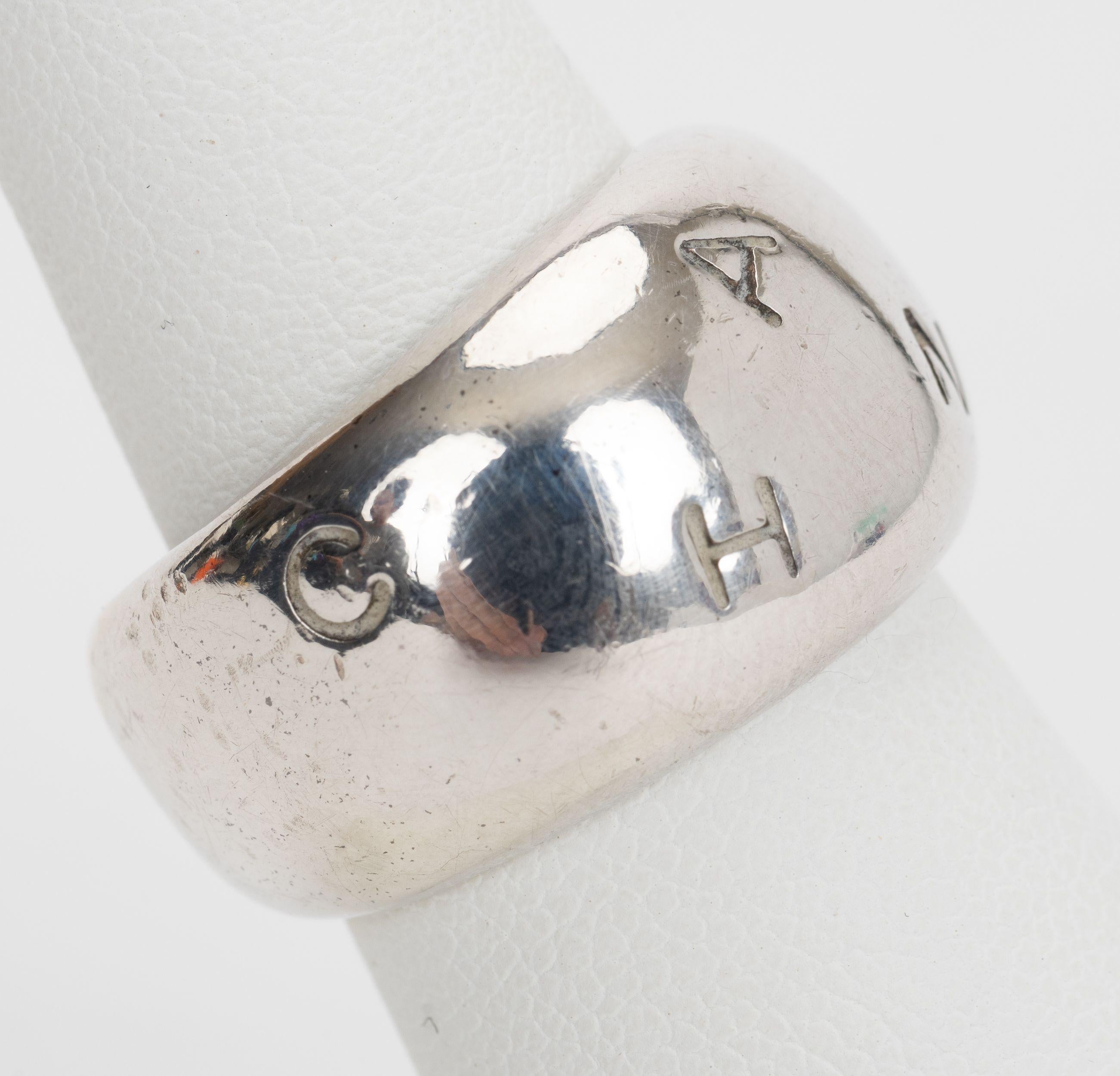 The Chanel logo ring is fun and playful as the CHANEL is randomly placed around the silver ring.
Size 6.5. Comes with velvet pouch.