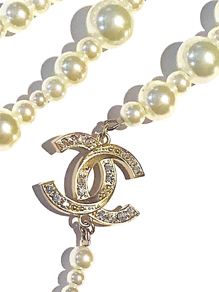 Chanel elegant three strand pearl necklace with rhinestone rondelles and rhinestone CC logo enhancers. Faux pearls have glass interior and are in five sizes of 3, 5, 7, 9 and 11 mm. Two satin gold CC logos. The larger is 1 inch wide and 3/4 inch