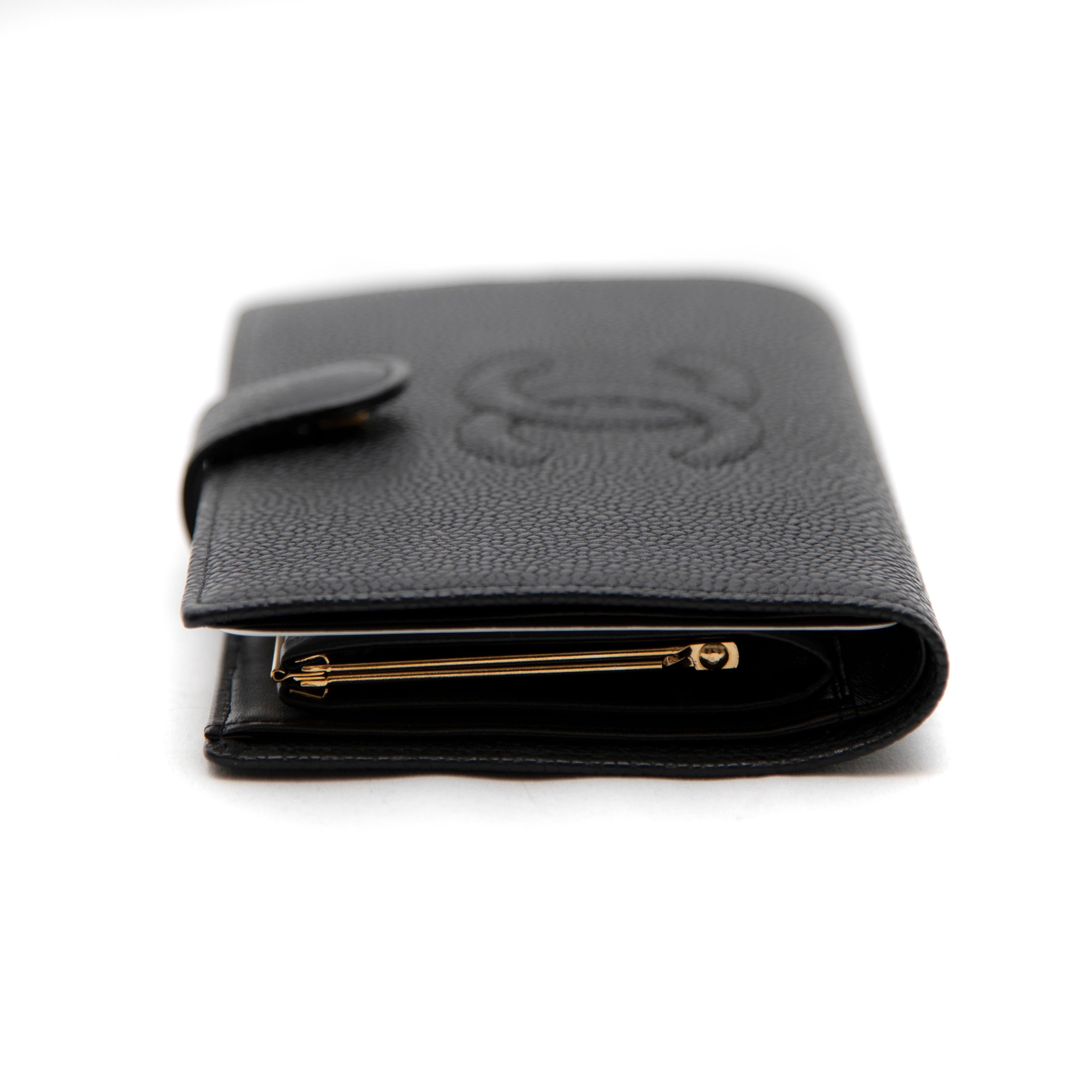 This timeless Chanel long bifold wallet in luxurious black caviar leather is both elegant and functional. Featuring the iconic Chanel craftsmanship, it offers ample storage for your essentials while maintaining a sleek, classic look. With multiple