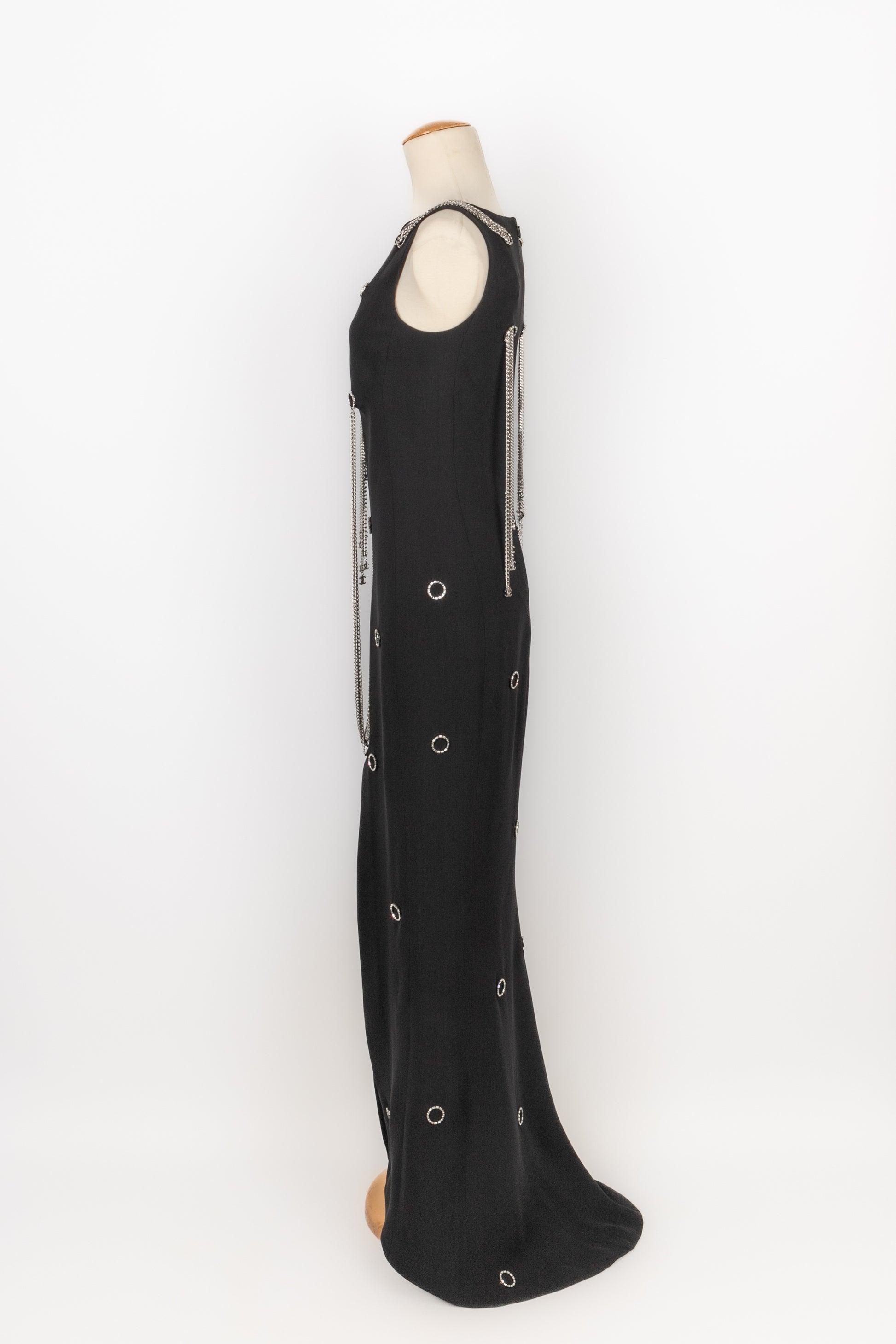 Chanel - (Made in France) Long black silk dress decorated with golden metal and rhinestones. Size 34FR. 2008 Spring-Summer Collection, under the artistic direction of Karl Lagerfeld.

Additional information:
Condition: Good condition
Dimensions: