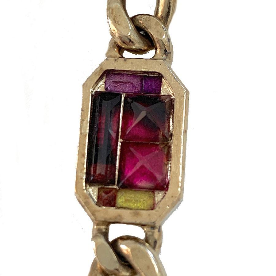 Long Chanel necklace with a big CC Logo covered with different colors of pink, purple and light orange-brown rhinestones. The necklace is 99 cm long and has been made in 2015 in France as written on the hallmark inscribed on the clasp. The Necklace