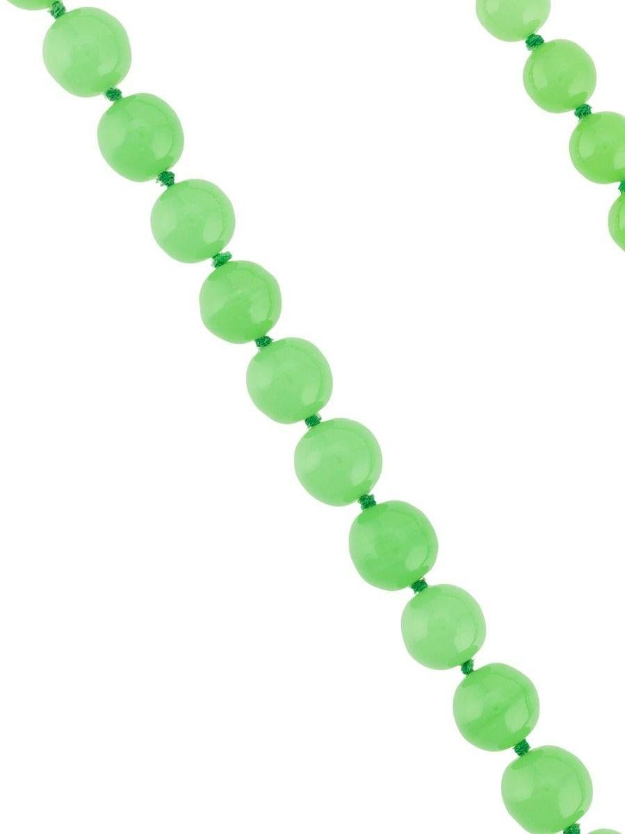 Crafted in France, this elegant, pre-owned necklace from Chanel is a unique piece that adds a touch of classic sophistication to any outfit and showcases a long string of jade green glass sphere-shaped embellishments and gold-toned metal accents.
