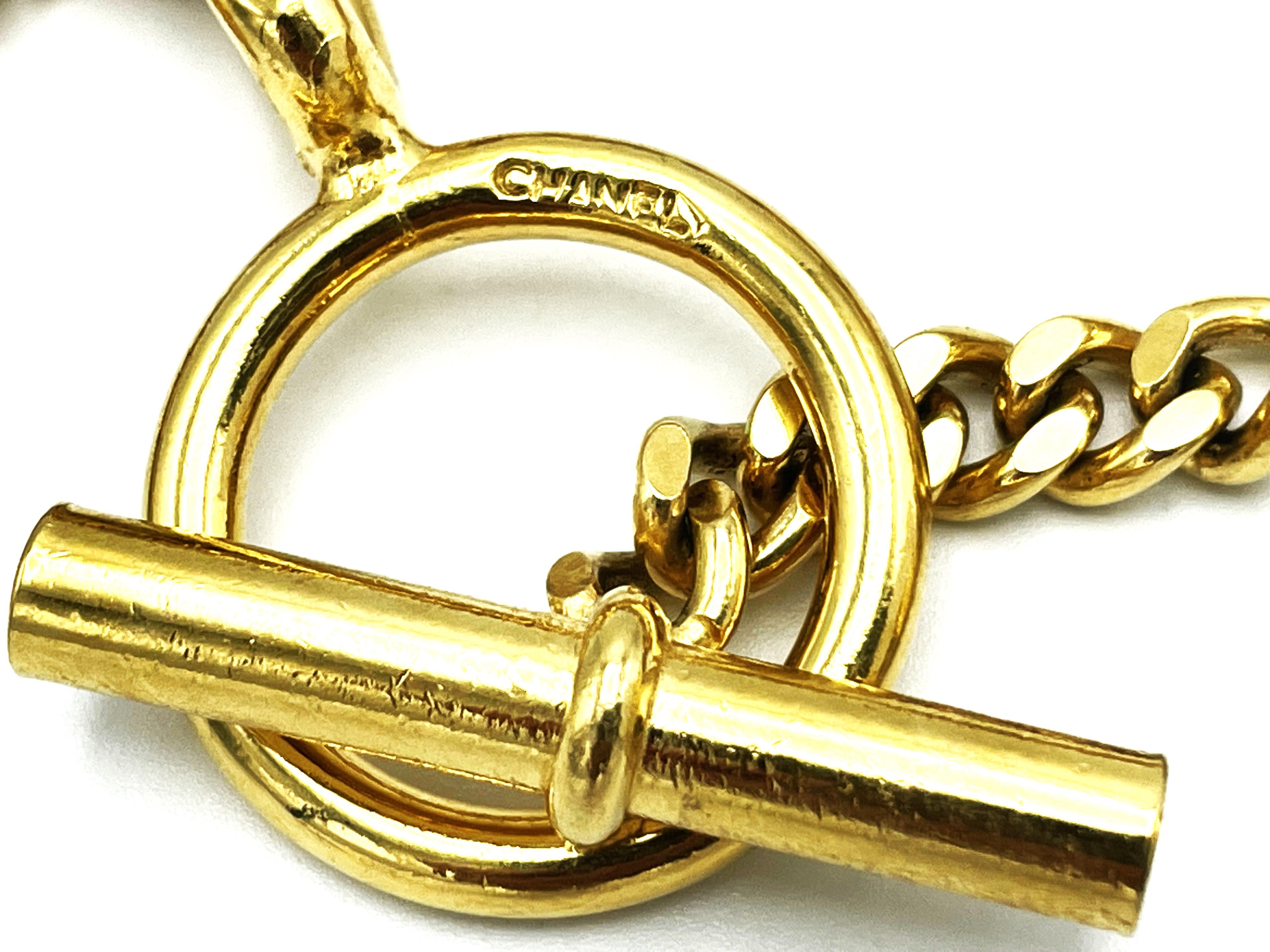 Women's CHANEL lucky charm bracelet with 7 iconic Chanel pendants gold-plated, 1990 For Sale
