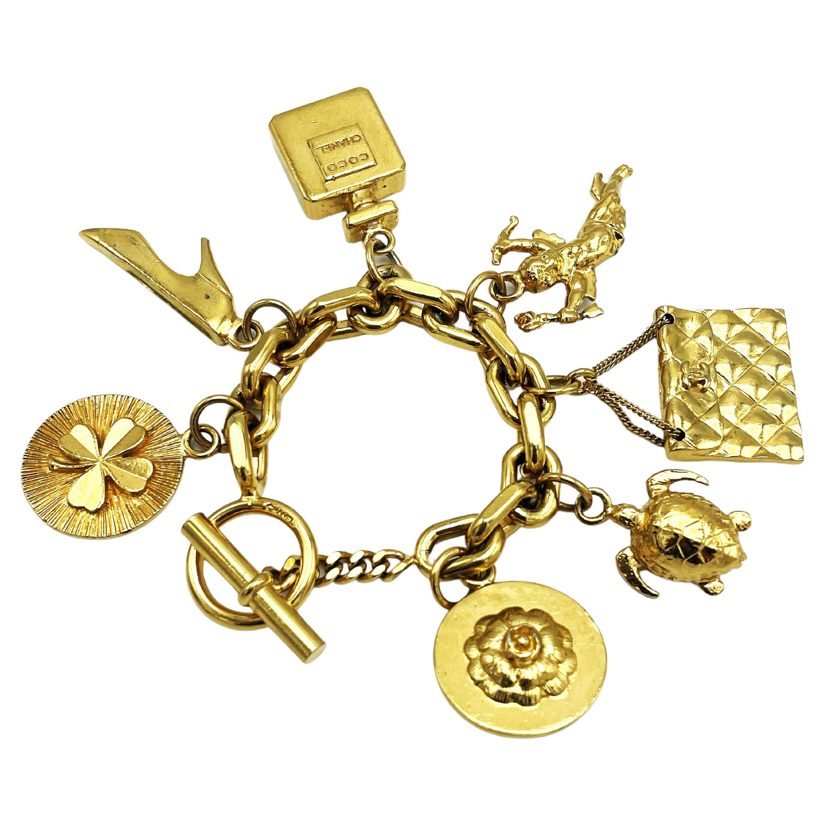 CHANEL lucky charm bracelet with 7 iconic Chanel pendants gold-plated, 1990 For Sale