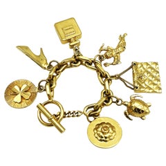Retro CHANEL lucky charm bracelet with 7 iconic Chanel pendants gold-plated, 1990