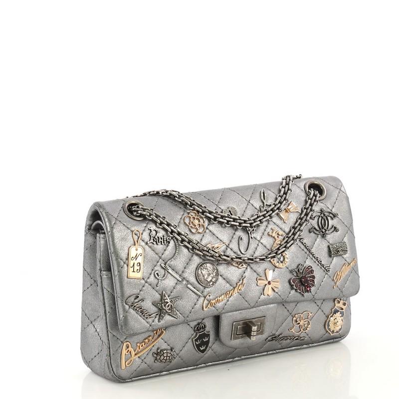 This Chanel Lucky Charms Reissue 2.55 Flap Bag Quilted Aged Calfskin 225, crafted in metallic silver glazed calfskin, features reissue chain strap, assorted metal Chanel charms, and aged silver-tone hardware. Its mademoiselle turn-lock closure opens
