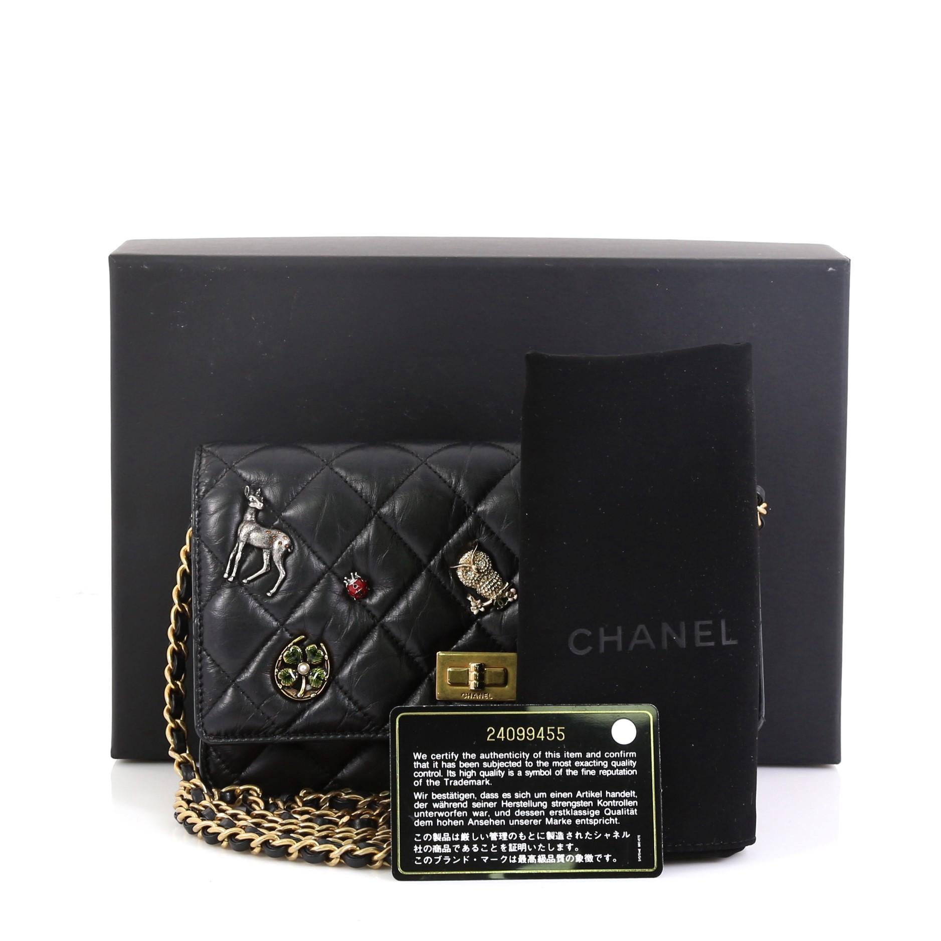 This Chanel Lucky Charms Reissue Wallet on Chain Quilted Calfskin, crafted in black diamond quilted calfskin leather, features Chanel's lucky charm symbols, woven in leather chain link strap, mademoiselle decorative clasp on the front flap, exterior