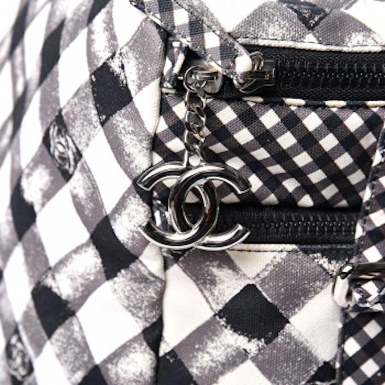 Picnic in style with this adorable novelty Chanel bag! Circa 2011, this Chanel lunch box bag is crafted from black canvas gingham and features the iconic CC logo, two zipper closures with a CC pull, silver toned hardware and an adjustable shoulder