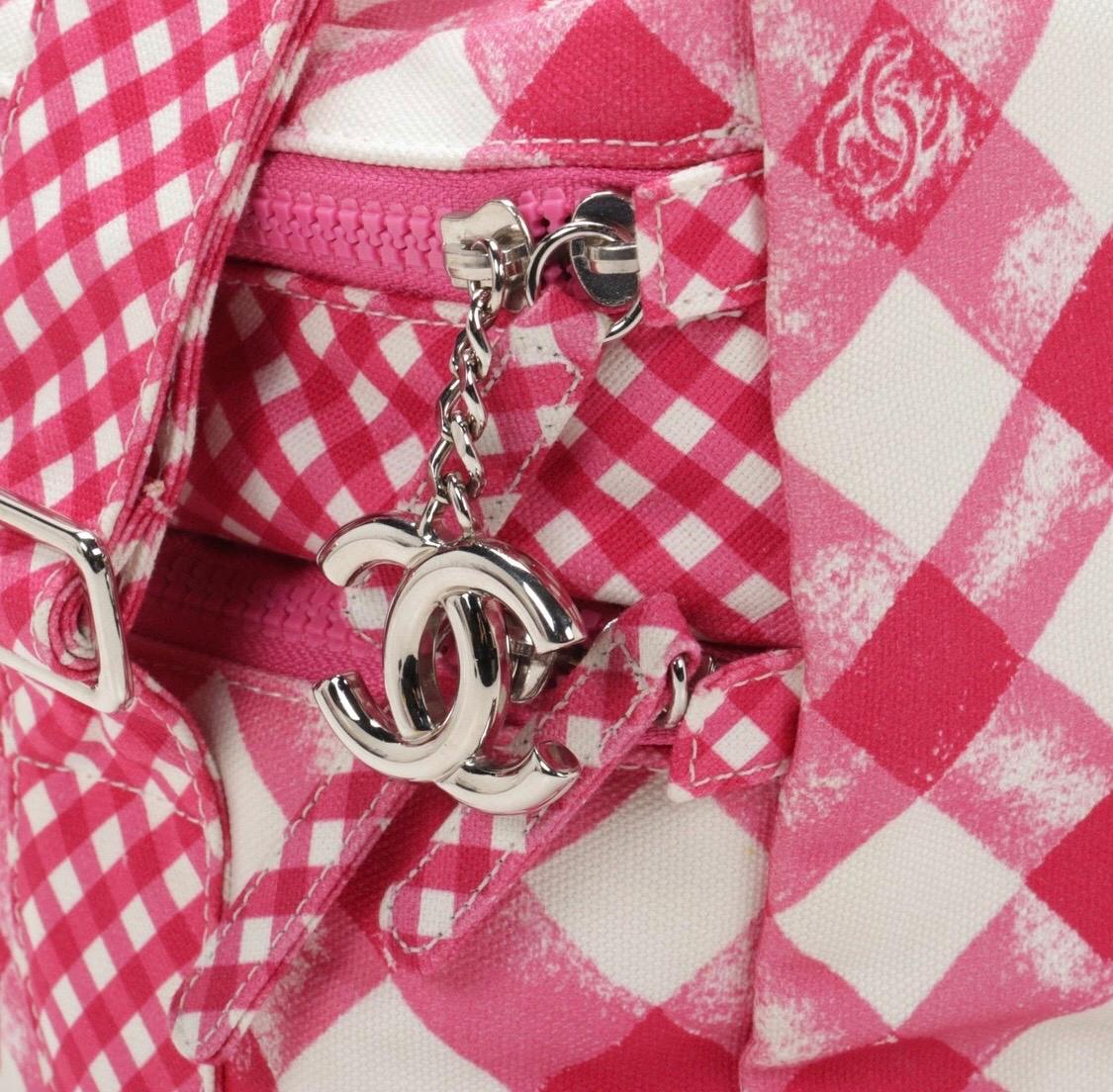 Picnic in style with this adorable novelty Chanel bag! Circa 2011, this Chanel lunch box bag is crafted from pink canvas gingham and features the iconic CC logo, two zipper closures with a CC pull, silver toned hardware and an adjustable shoulder