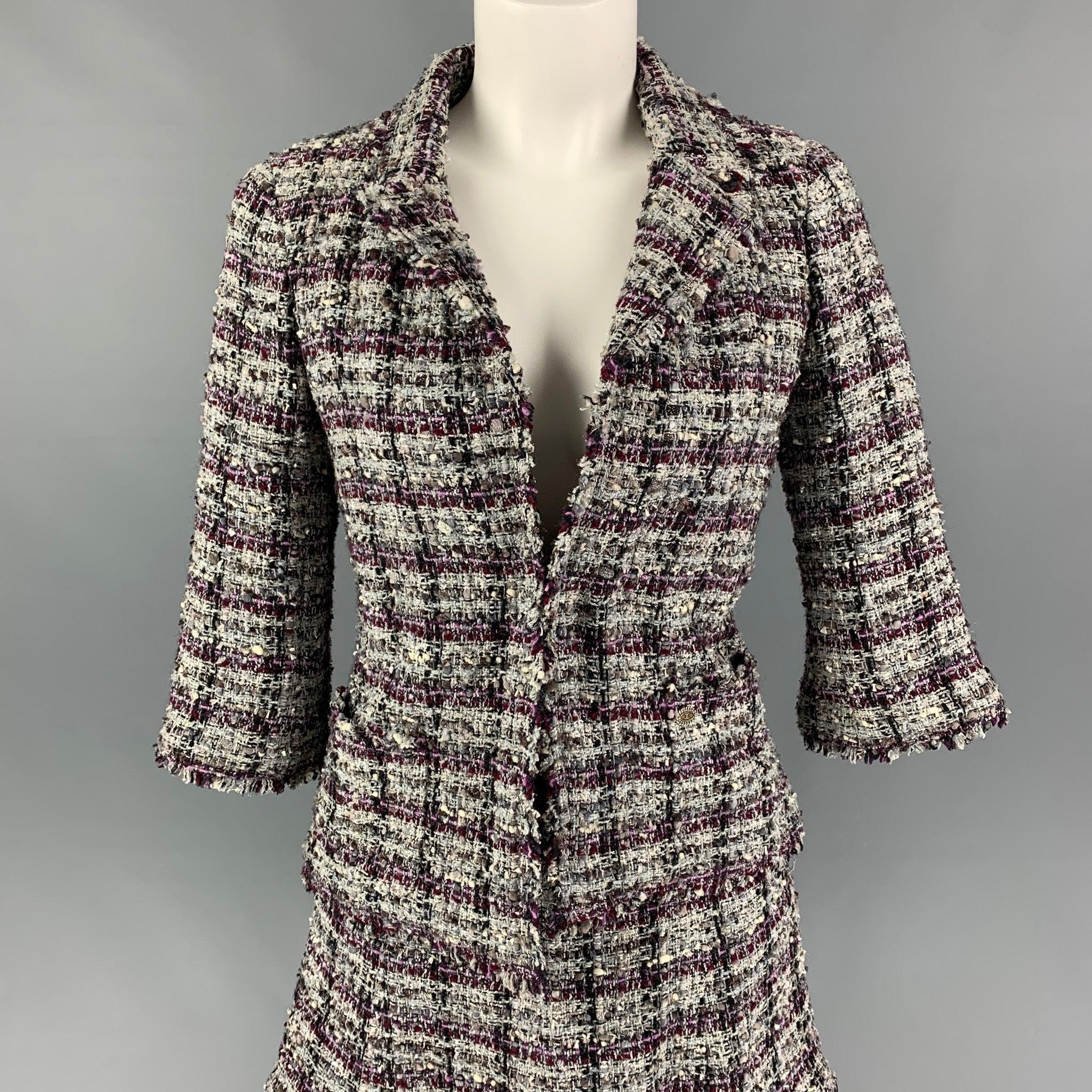 CHANEL skirt set comes in a purple & grey boucle polyester blend featuring a notch lapel, silver tone buttons, open front, and a matching layered skirt. Includes extra fabric. Made in France.
Very Good
Pre-Owned Condition. 

Marked:   M4137 05A / 36