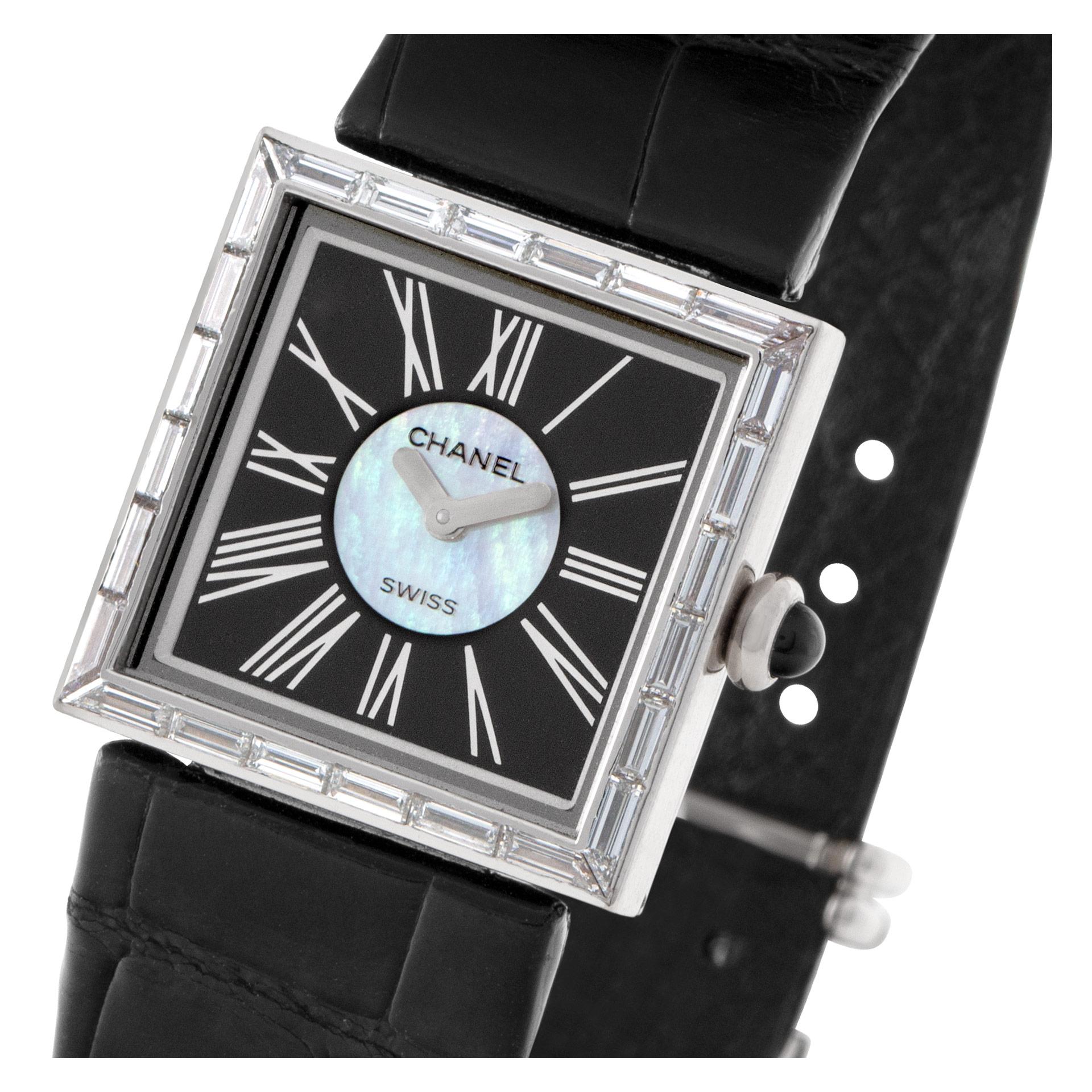 ESTIMATED RETAIL: $18,000 YOUR PRICE: $9,800 - Ladies Chanel Mademoiselle in 18k white gold with black & silver Roman Numeral dial surrounded by original baguette diamond bezel on a black leather strap with an 18k White Gold Two-Piece buckle. This