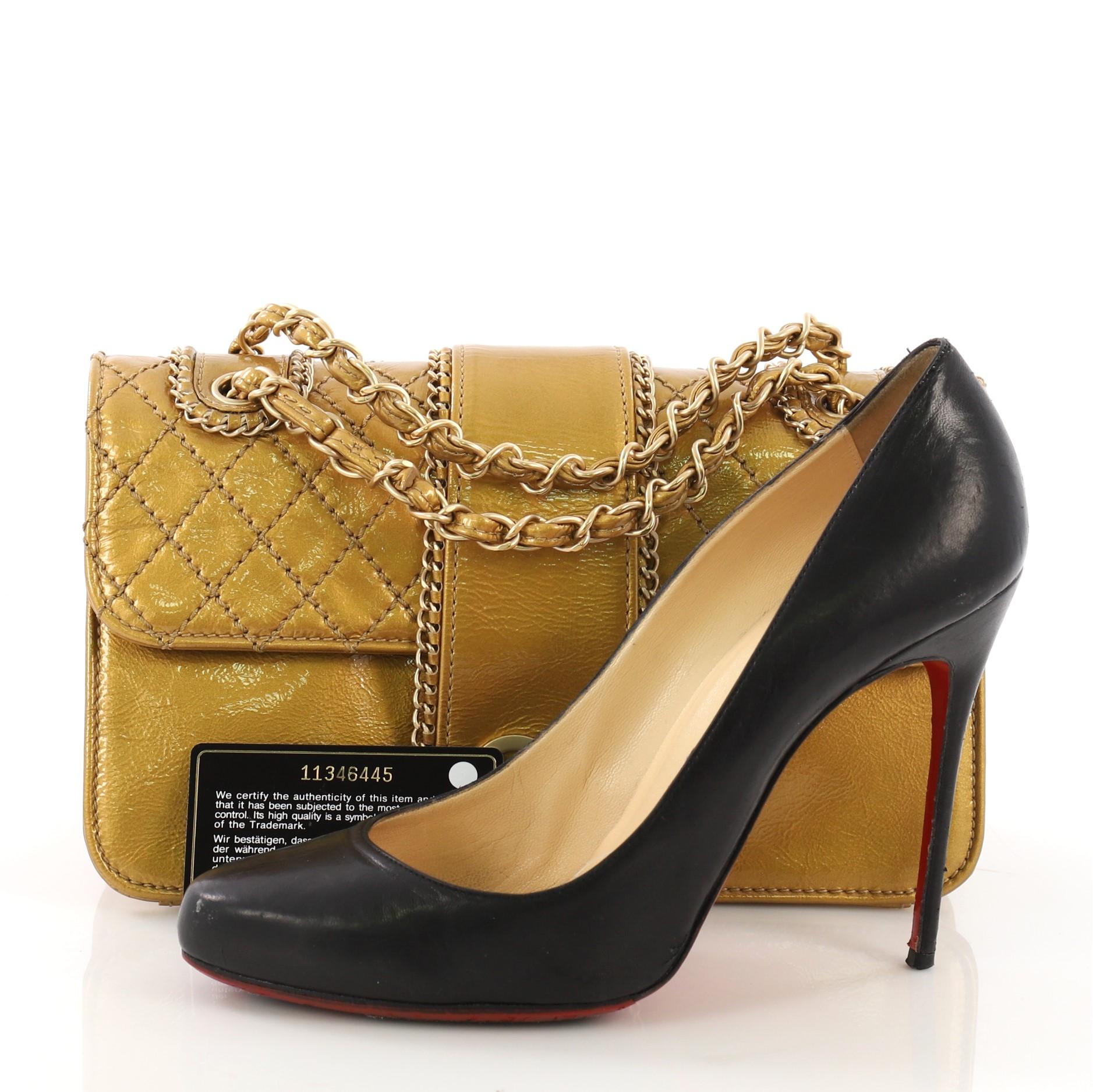 This Chanel Madison Flap Bag Quilted Patent Medium, crafted from gold quilted patent leather, features woven-in leather chain strap, chain trim details, and matte gold-tone hardware. Its CC turn-lock closure opens to a beige satin interior with two