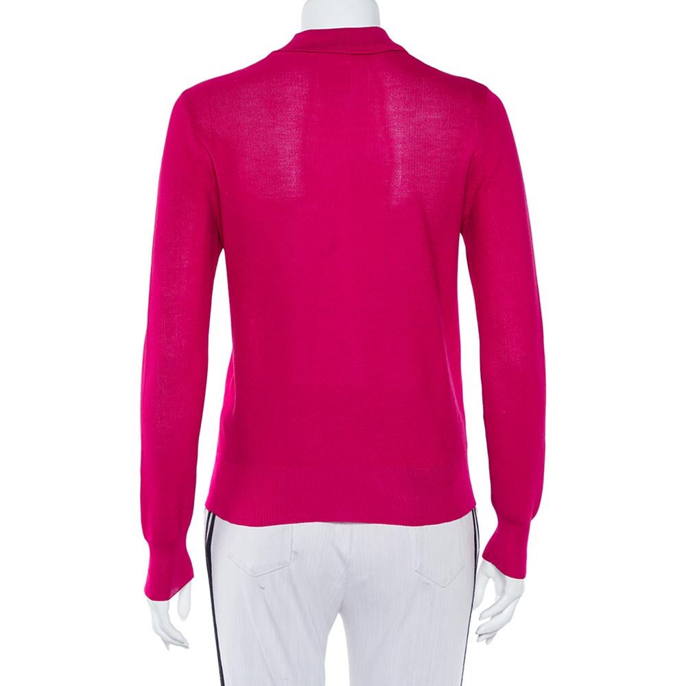 This magenta-hued polo t-shirt from Chanel will look amazing on you! It is made of silk and features a smart silhouette. It comes with classic collars and button fastenings and long sleeves. It will look best with casual jeans and sneakers.

