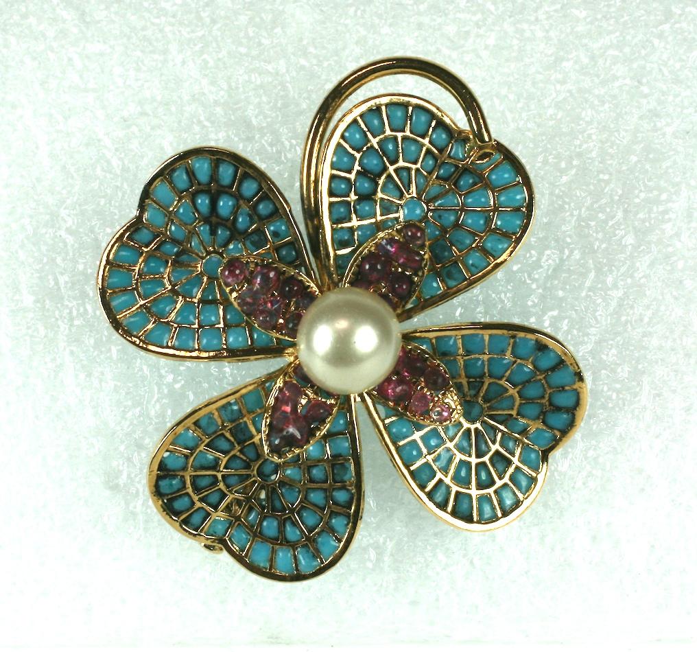 Chanel 1950 clover brooch. Clovers are another motif Chanel has revisited many times since the 1930s. This elaborate dimensional brooch derives from the Gripoix workshops in Paris. 
Pale turquoise and pale ruby poured glass enamel is set into a