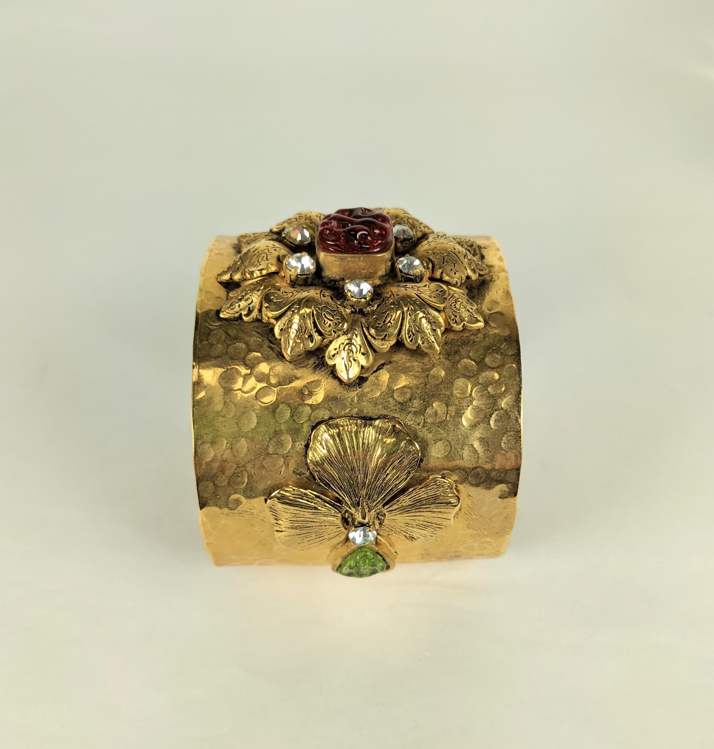 Chanel hand hammered gilt bronze floral cuff bracelet by Maison Gripoix, Paris. The central floral motif of baroque metal petals with center of ruby jelly molded poured glass enamel and crystal rhinestone paste. The side motifs have gilt flower