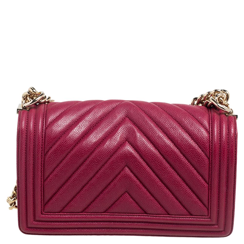 A popular design, this Boy flap bag is no less grand than the other Chanel's iconic handbags. Exquisitely crafted from maroon Caviar leather, it bears the signature label inside the fabric interior, the signature CC push lock on the flap, and