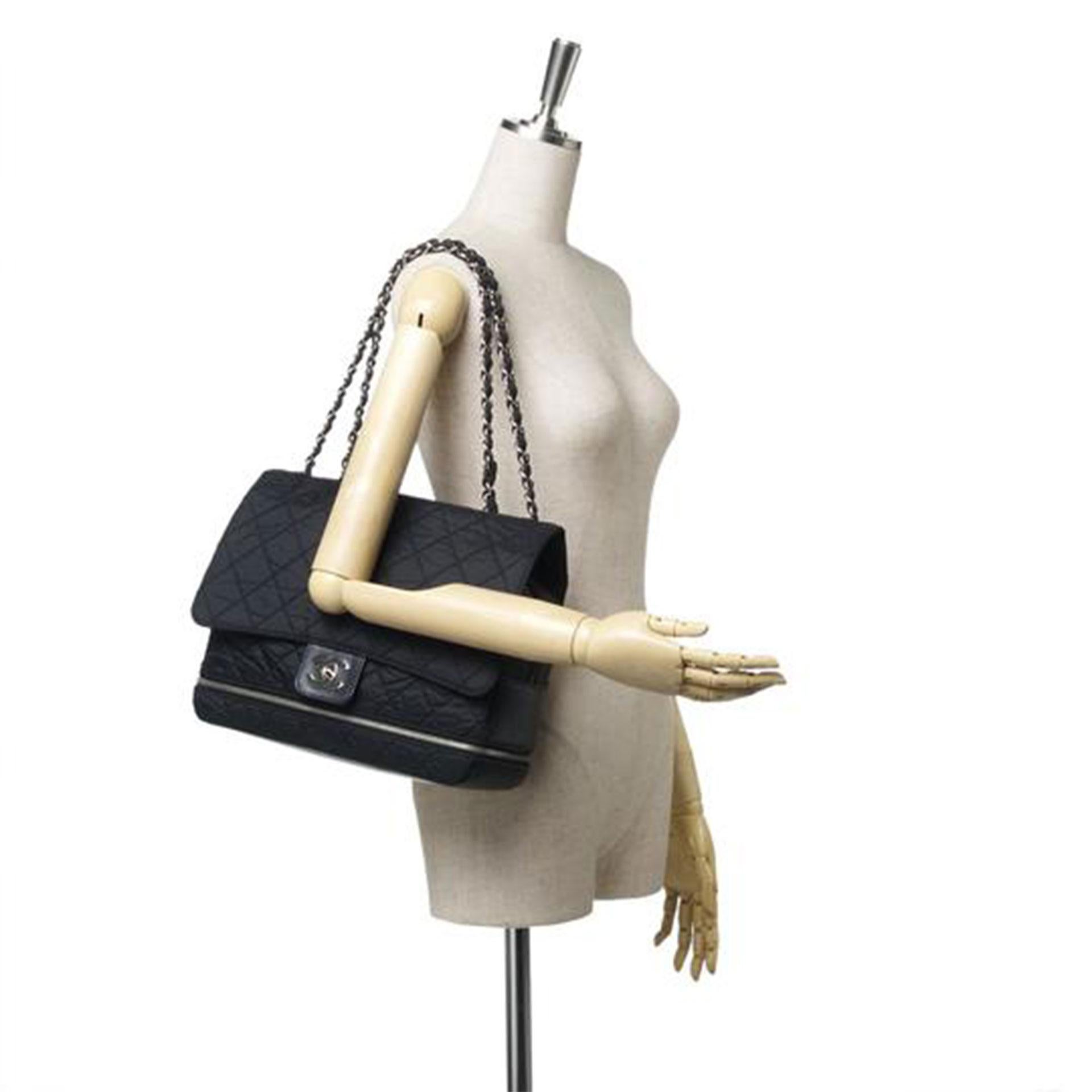This shoulder bag features a nylon body, silver-tone chain straps, zip around detail, front flap with interlocking CC twist lock closure, top zip closure, exterior slip pocket and interior zip pocket.


Inclusions: 
Dust Bag
Authenticity