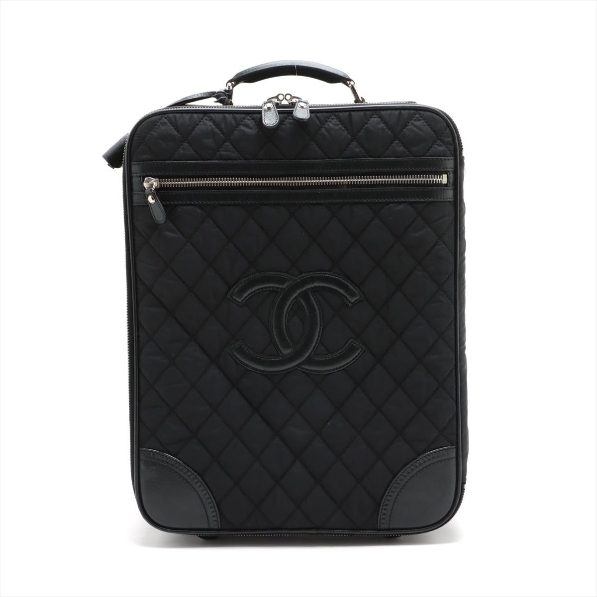 The Chanel Matelasse Nylon Leather Carry Case in black is an epitome of luxury and sophistication, blending the iconic Chanel design elements with practicality. The carry case features a quilted nylon exterior, accented with leather trims, which