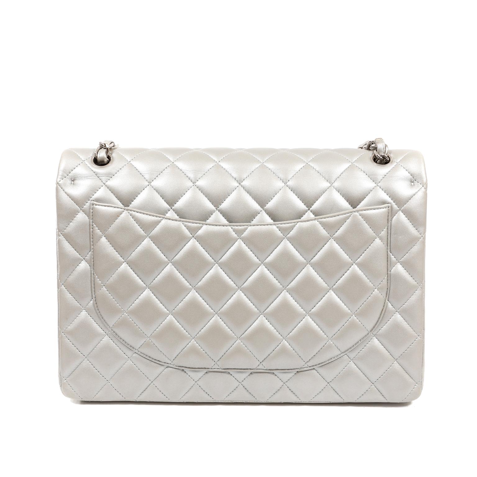 This authentic Chanel Matte Silver Lambskin Maxi Classic Flap is in very good condition.  The matte silver finish makes this Timeless Classic extra glamorous.  
Muted silver lambskin is quilted in signature Chanel diamond pattern.  Silver