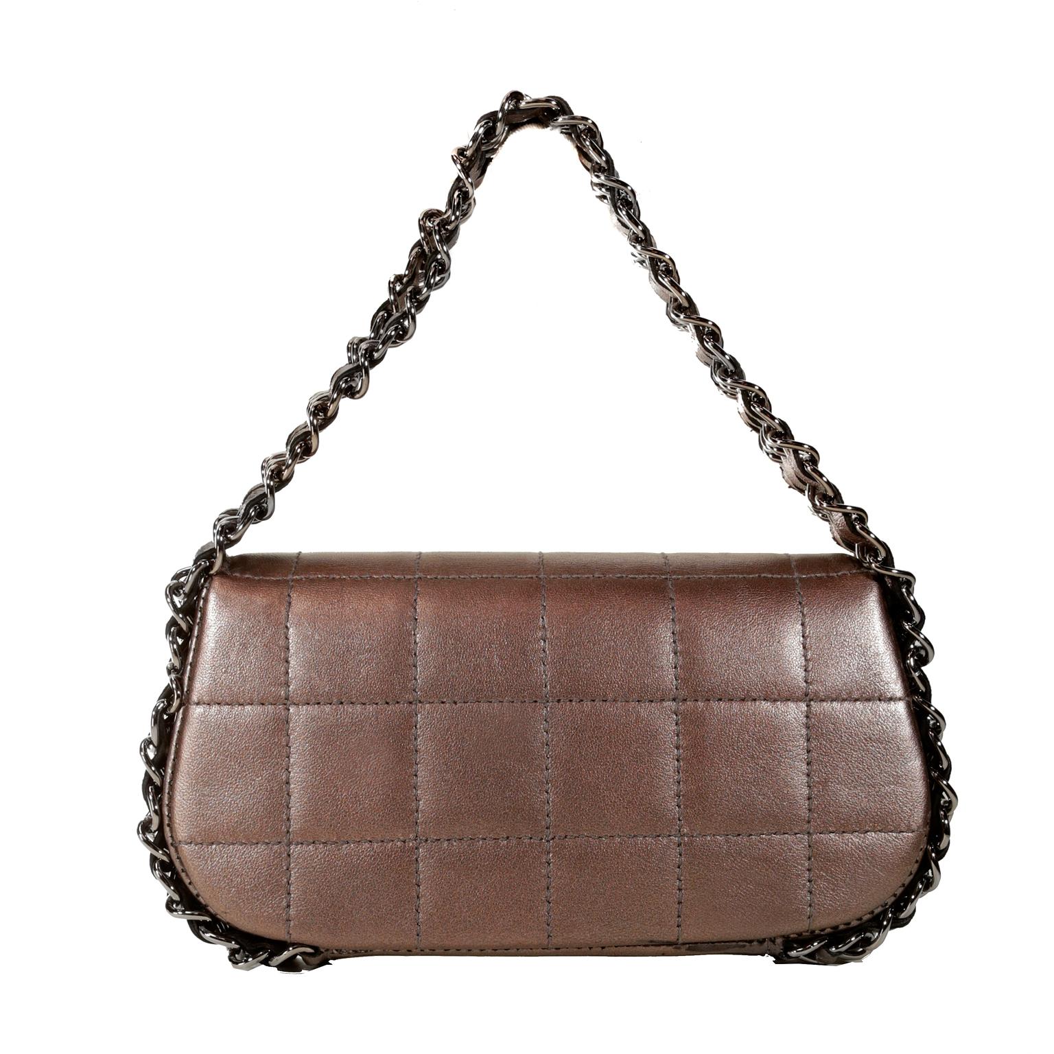 This authentic Chanel Mauve Metallic Leather Triple Chain Small Flap Bag is in beautiful condition. It has enjoyed a previous life and is not perfect. 
 Remarkably neutral mauve leather is stitched in a square pattern and has a subtle metallic