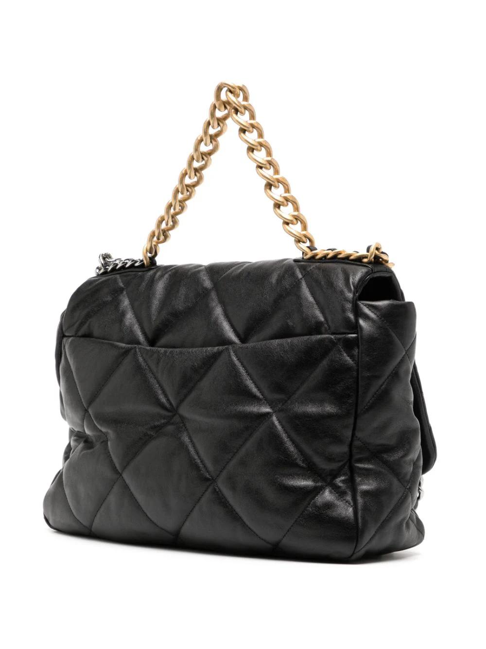 Chanel Maxi 19 Flap bag made of black calf leather. Featuring diamond quilting and a padded design. Signature interlocking CC turn-lock fastening and fold over top. Two chain-link shoulder straps with gold & silver-tone hardware. This bag was