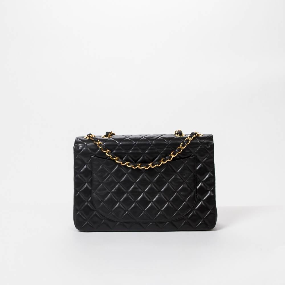 Maxi Jumbo Front Pocket in black calf leather, chain strap interlaced with black leather and gold tone front CC turn lock. Black leather lined interior with one slip pocket and zip pocket. Gold tone heat stamps 
