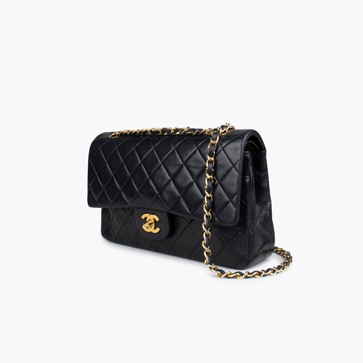 Black quilted lambskin Chanel Medium Classic Double Flap bag with

– Gold-tone hardware
– Convertible chain-link and leather shoulder strap
– Burgundy leather lining
– Single patch pocket at back
– Single zip pocket at flap underside, three