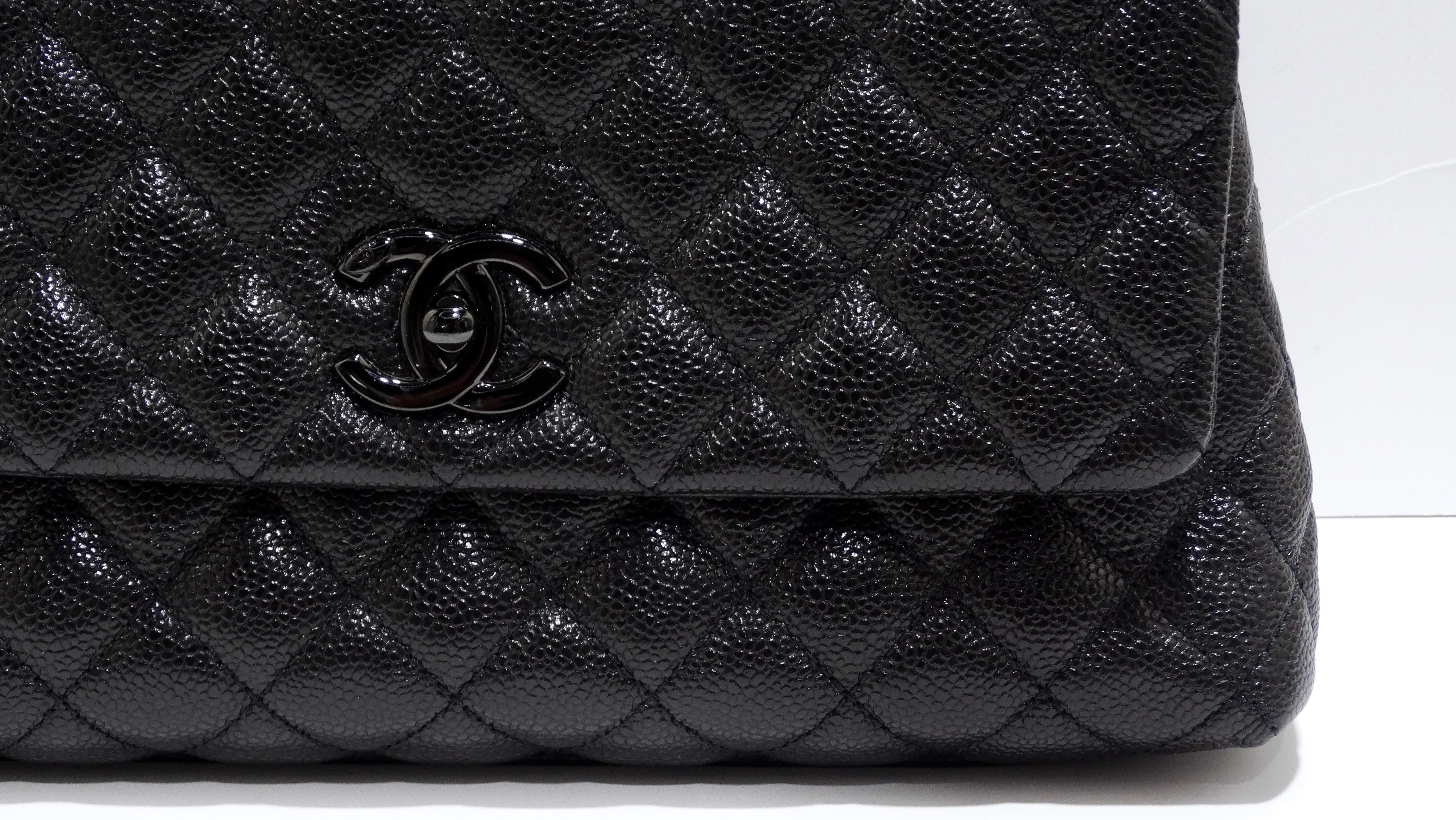 SEXY and SLEEK Chanel! From the wonderful and iconic Karl Lagerfeld, this is an authentic CHANEL Caviar Quilted Mini Coco Handle Flap in So Black. This chic tote is crafted of quilted black caviar leather. This can be worn in so many ways